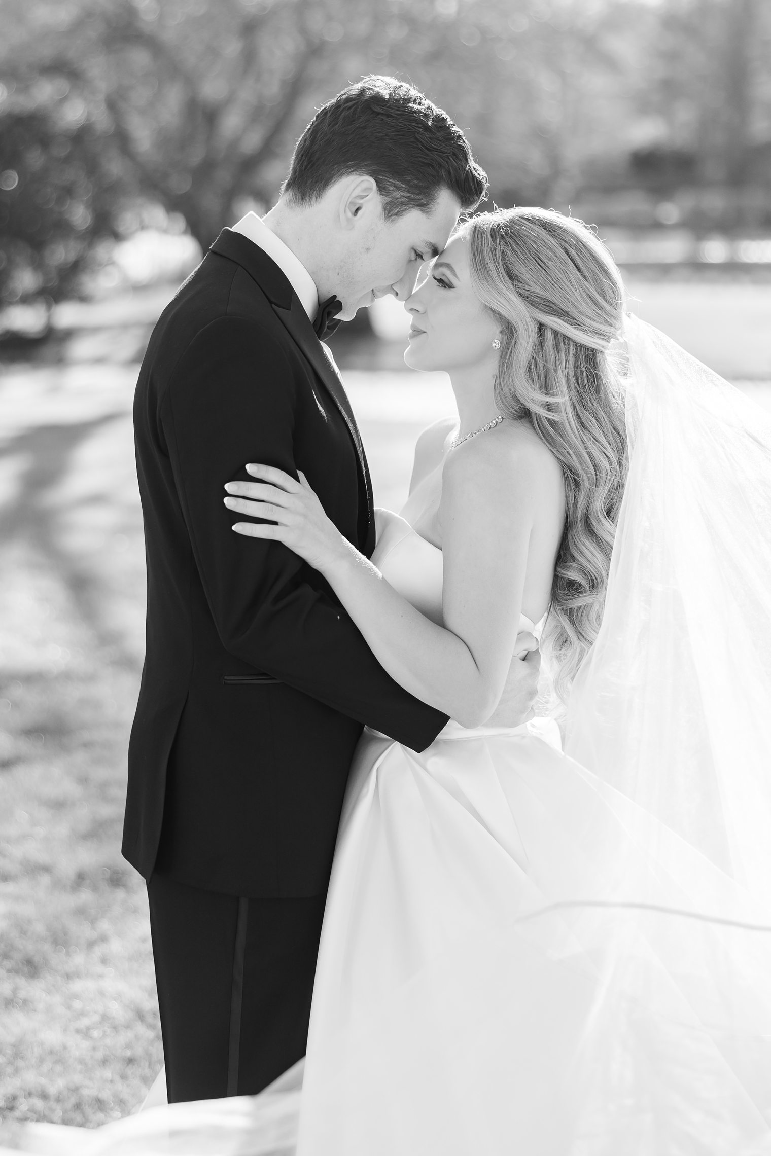 bride and groom posing their foreheads against each other 