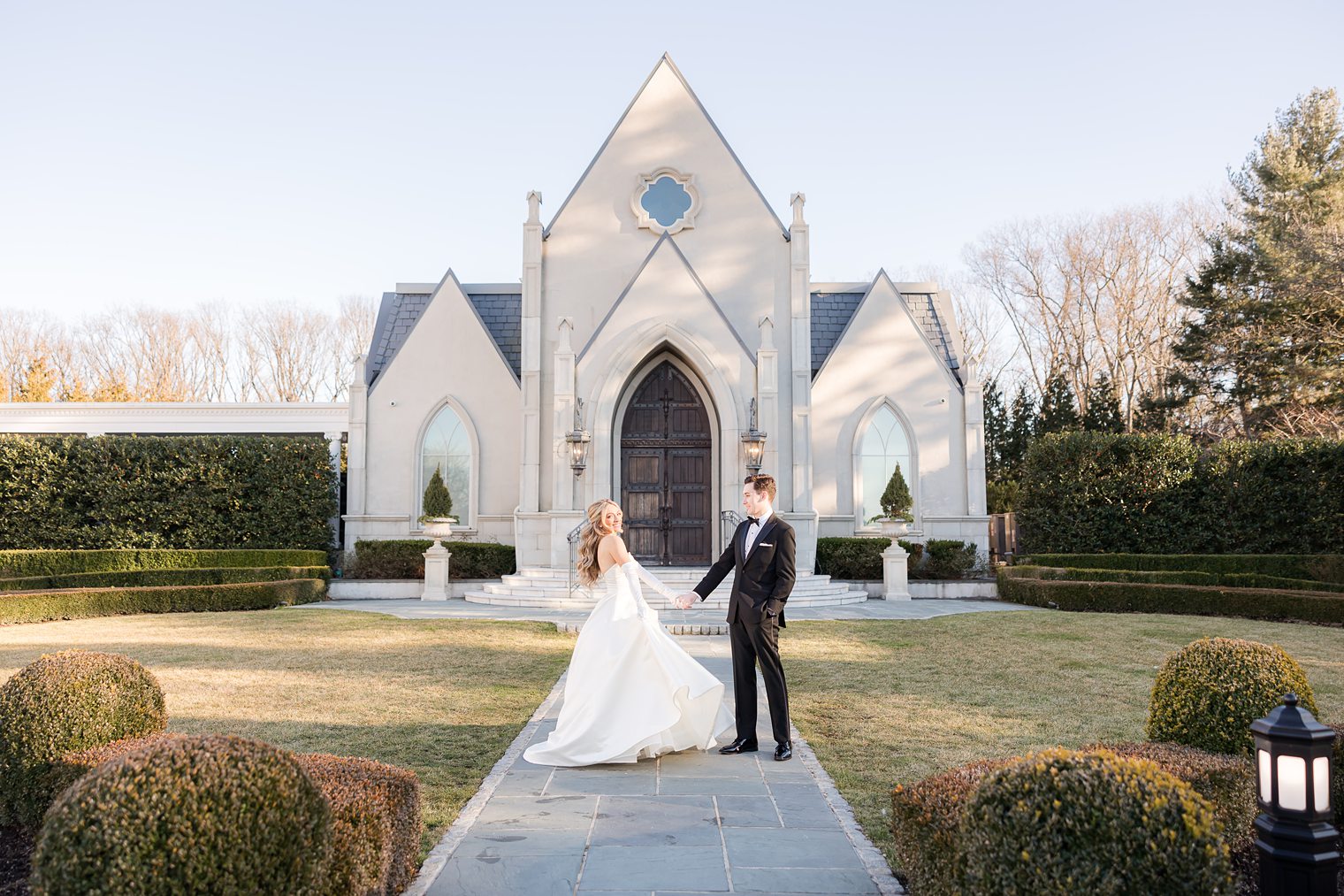 bride and groom in front of the church where they are going to say i do