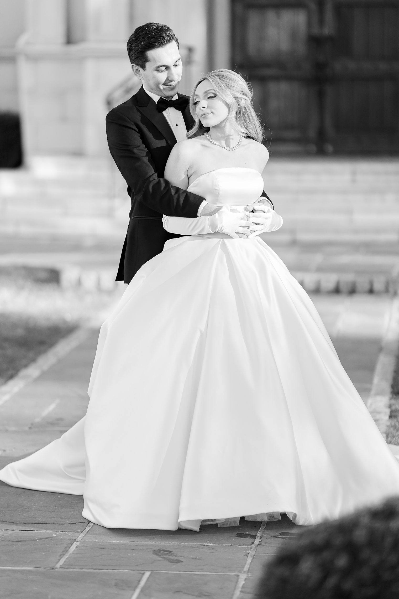 groom hugging his bride from the back 