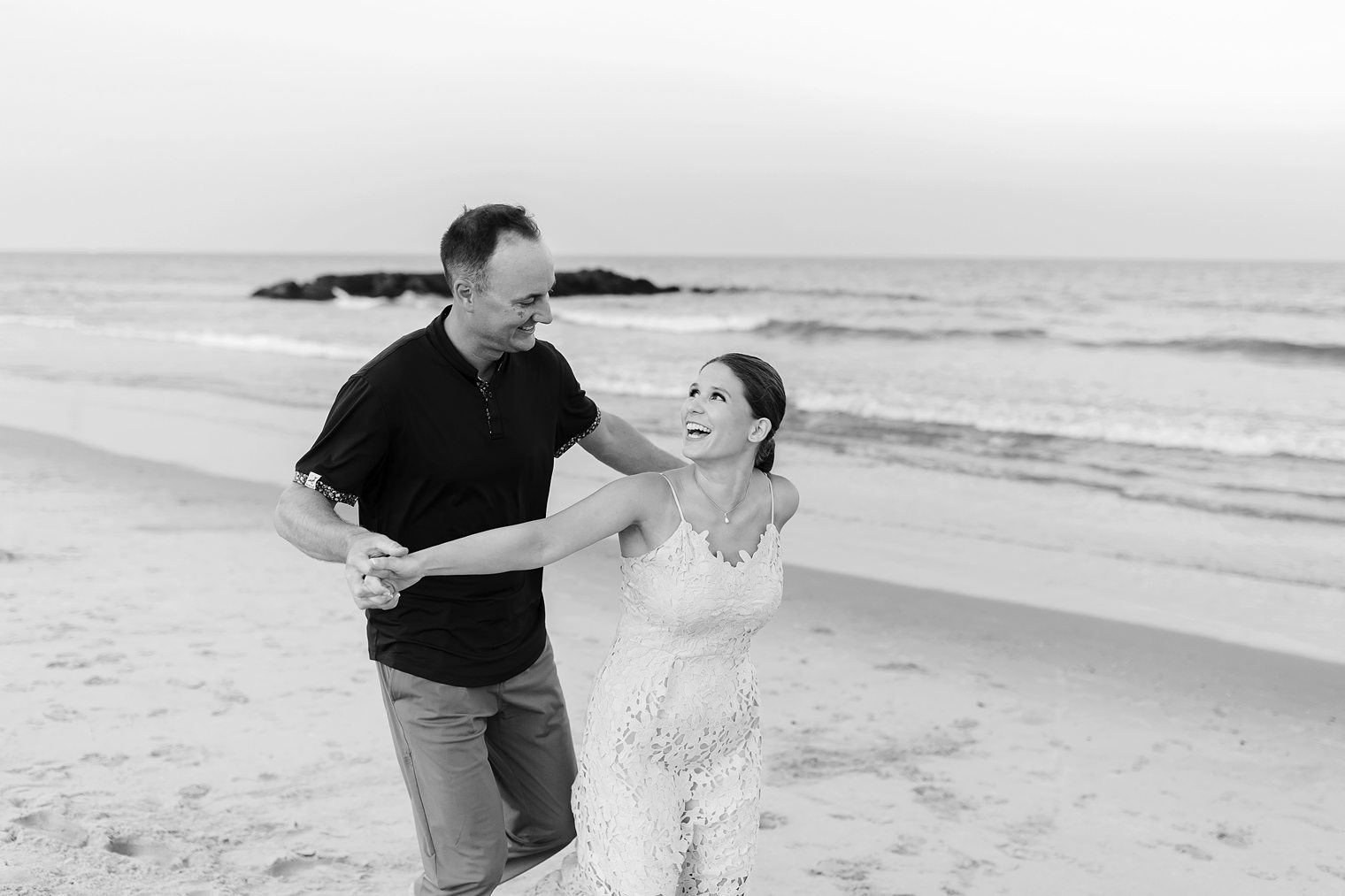 happy and playful couple enjoying their engagement session at Spring Lake