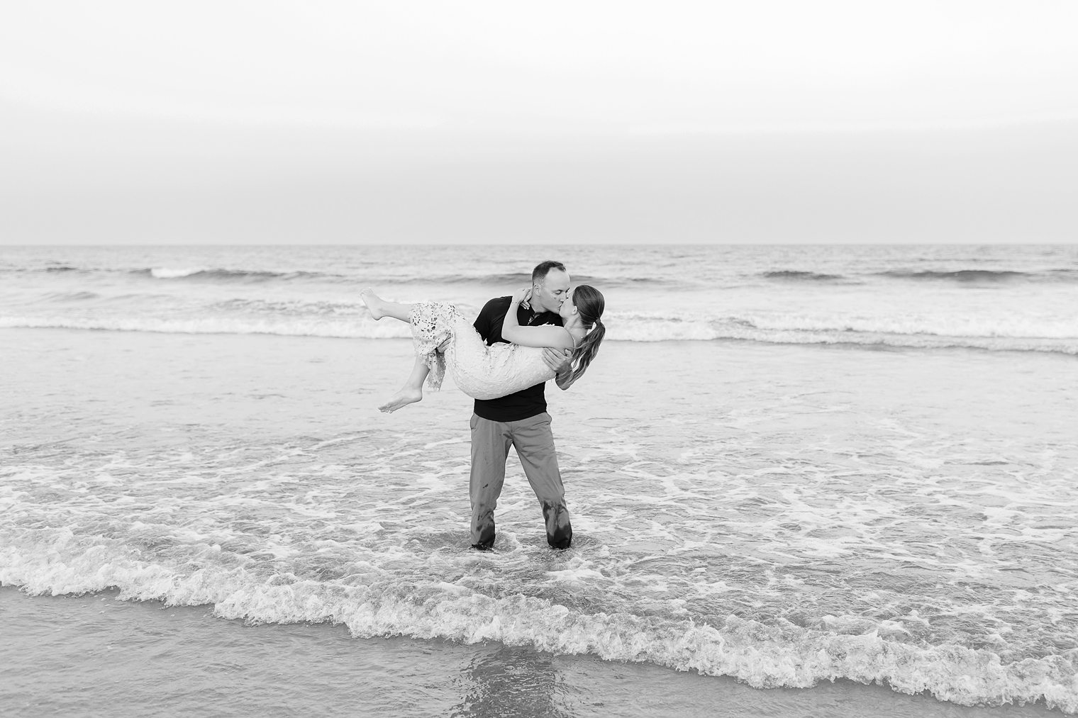 bride and groom sharing a kiss while they are in the sea 