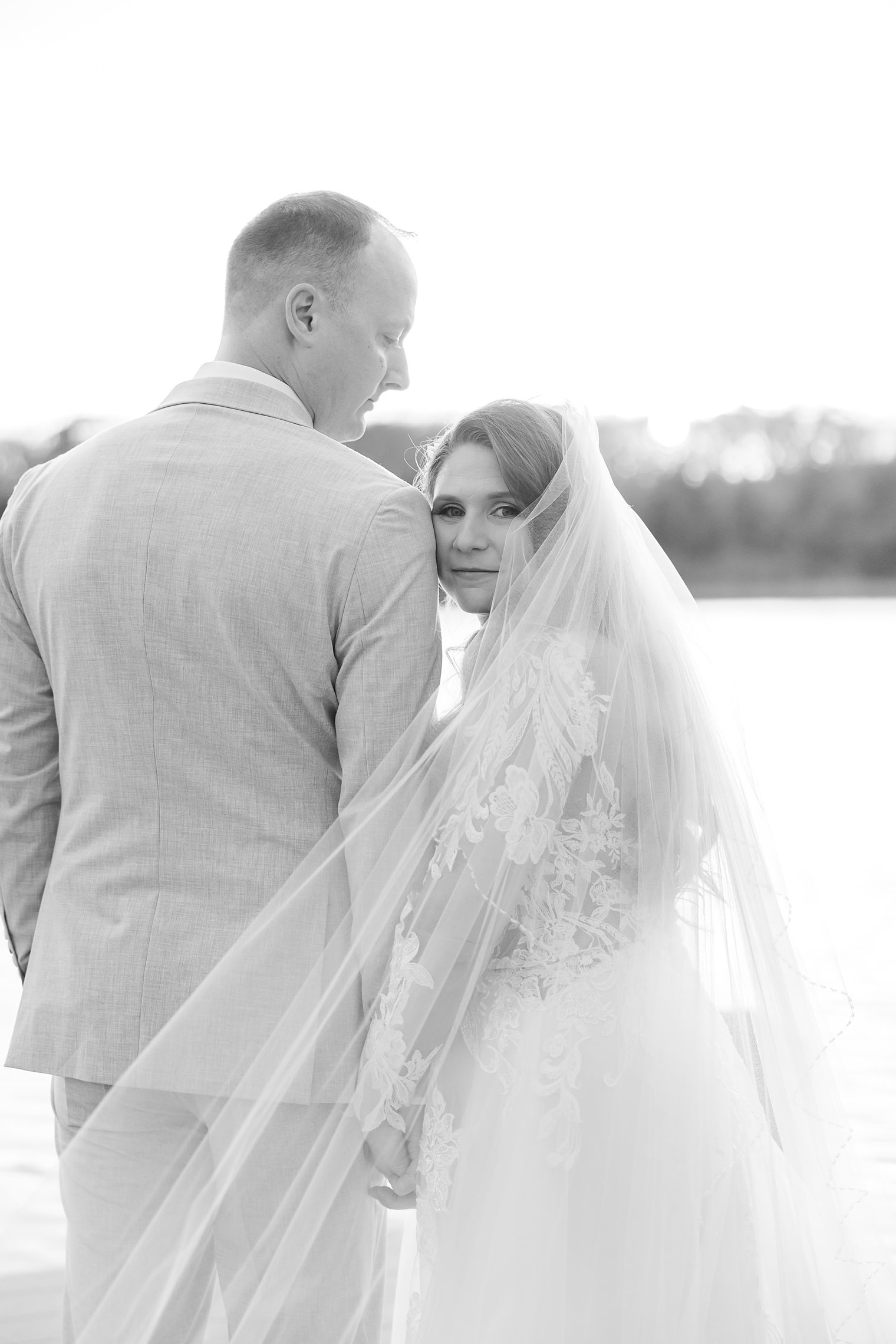 bride looking to the camera, while husband looking to his bride 