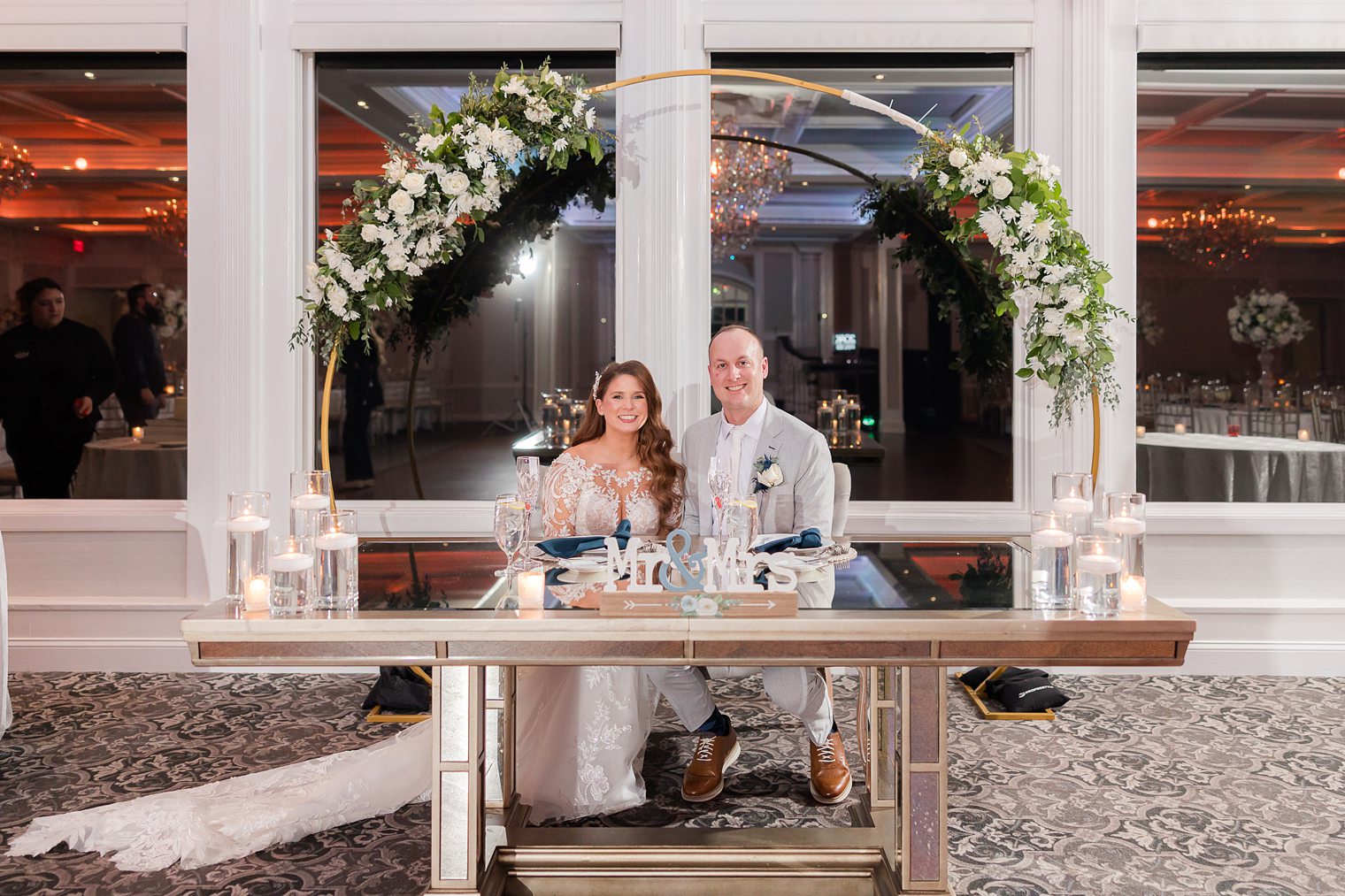 husband and wife sitting at their sweet heart table