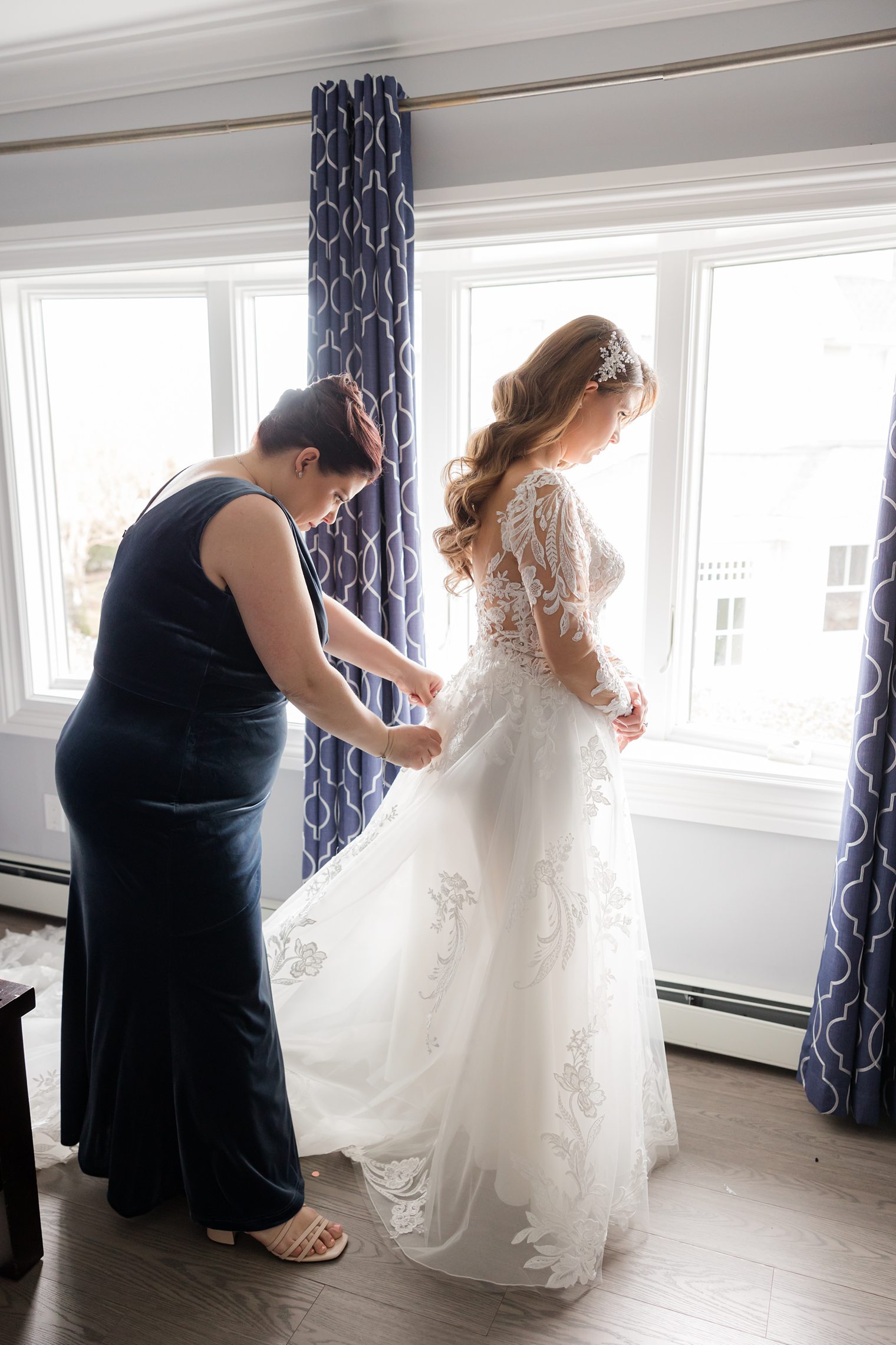 bridesmaid helping the bride to get ready 