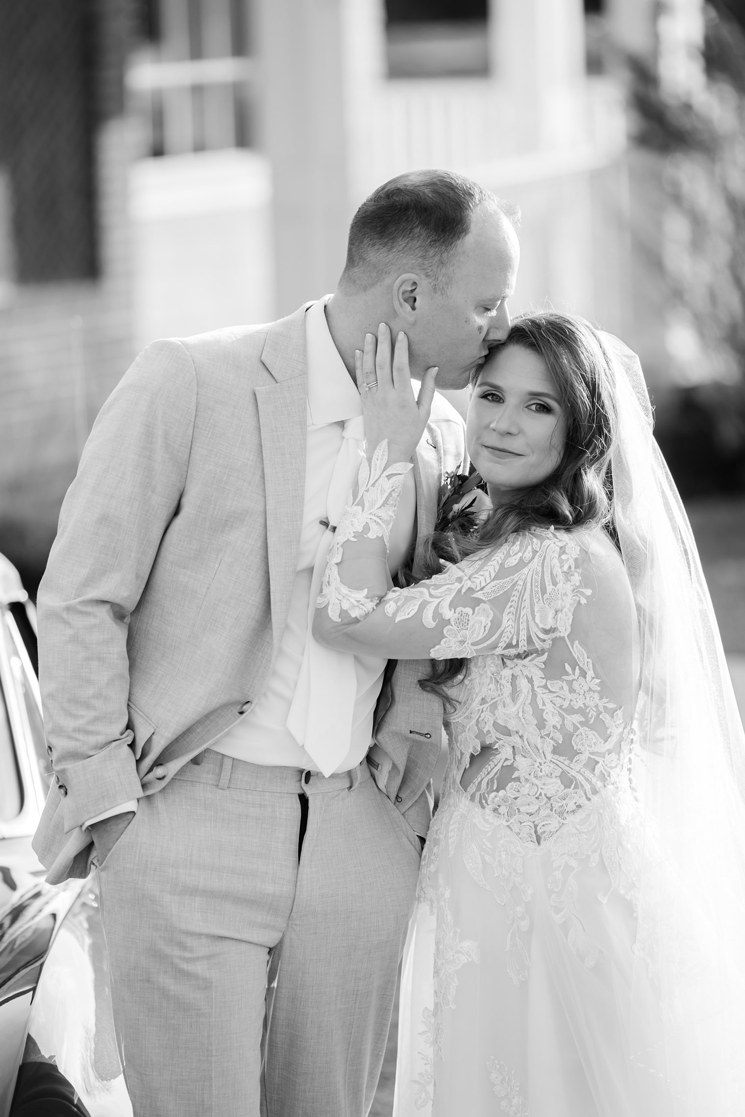 husband kissing his wife's forehead