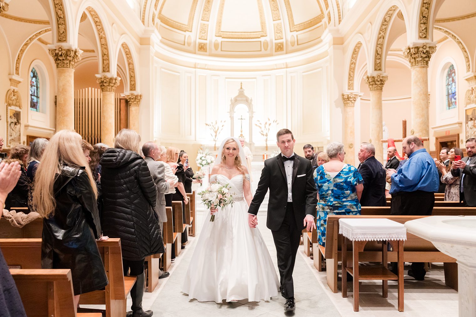 husband and wife walking out the aisle 