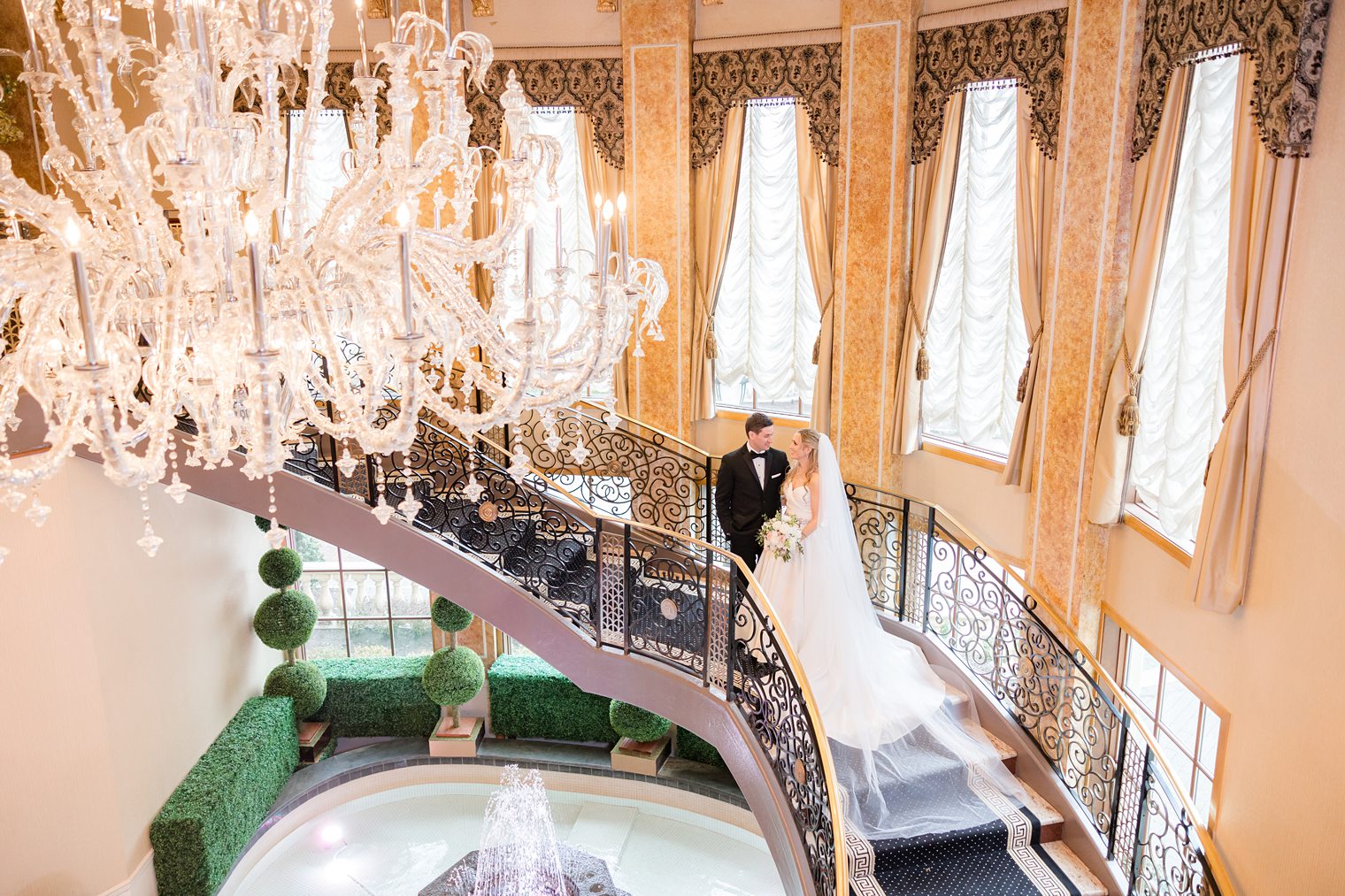 husband and wife posing in the stairs of the venue 