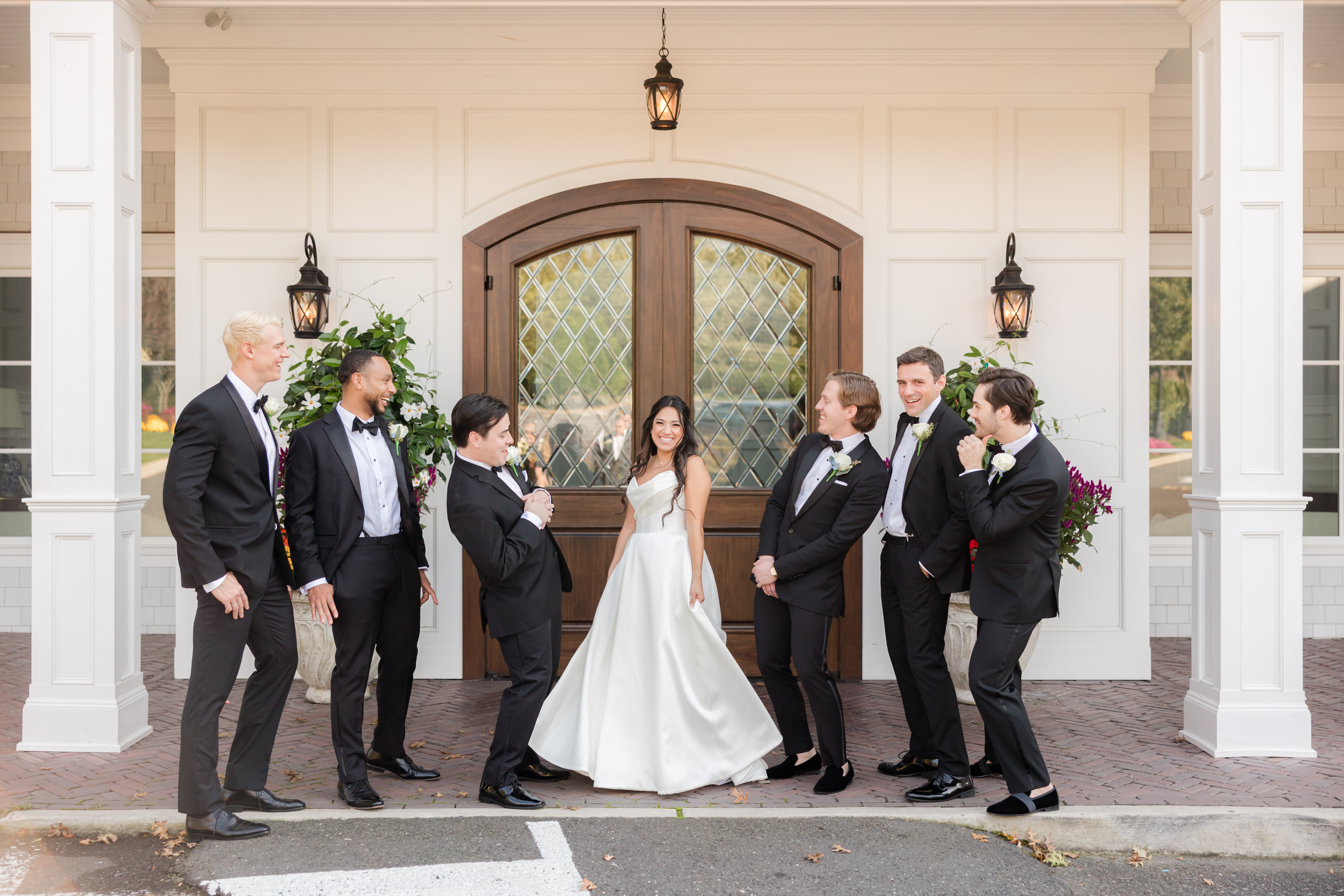 bride posing with the best men