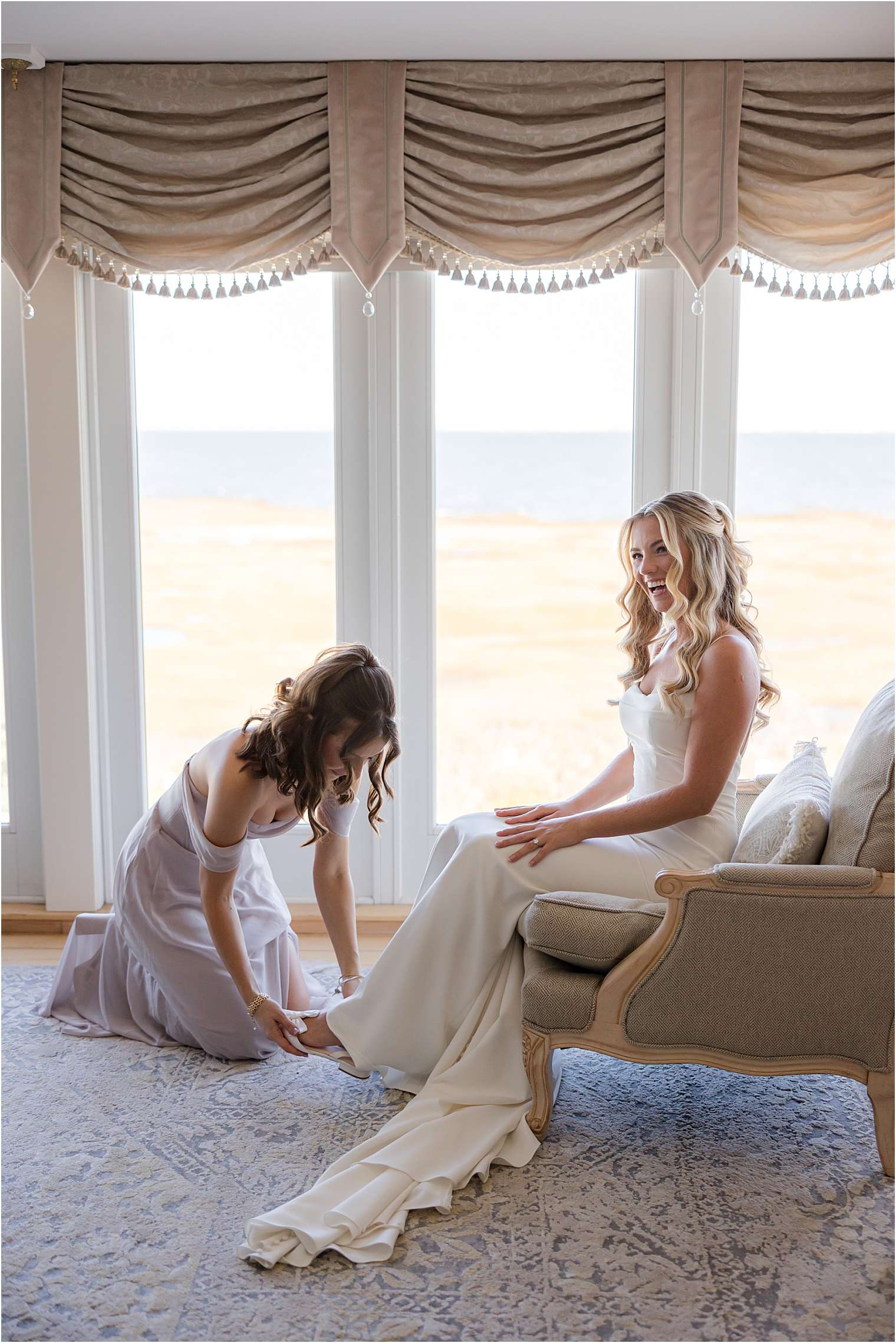 bridesmaid helping bride get dresssed