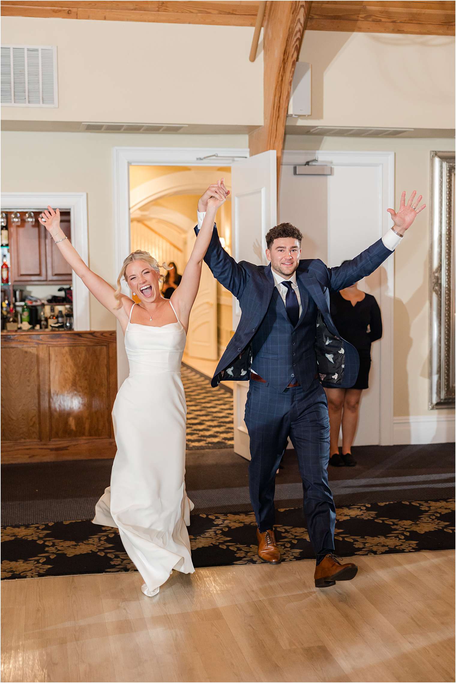 Bride and groom entering the ballroom