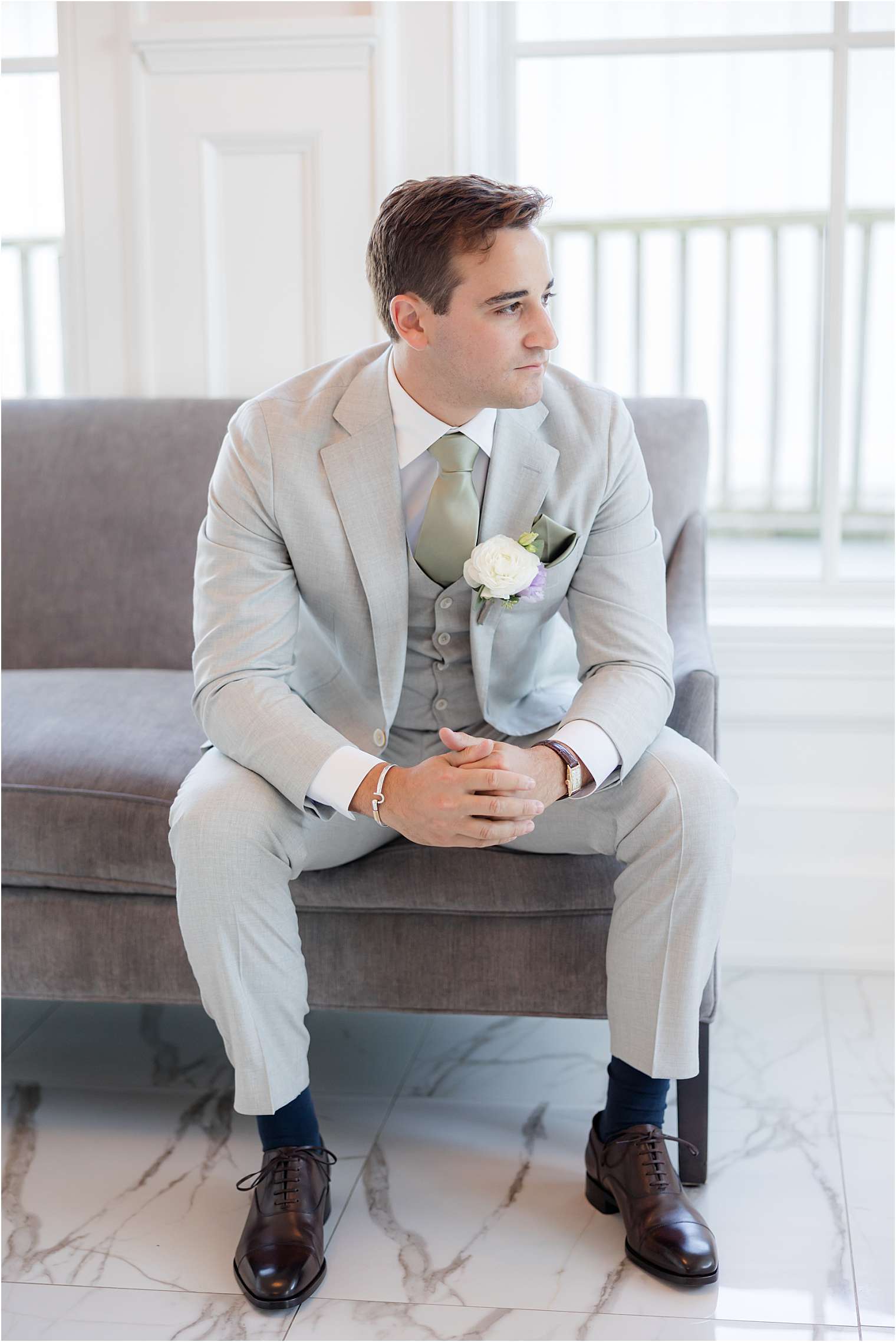 best man helping groom with final details