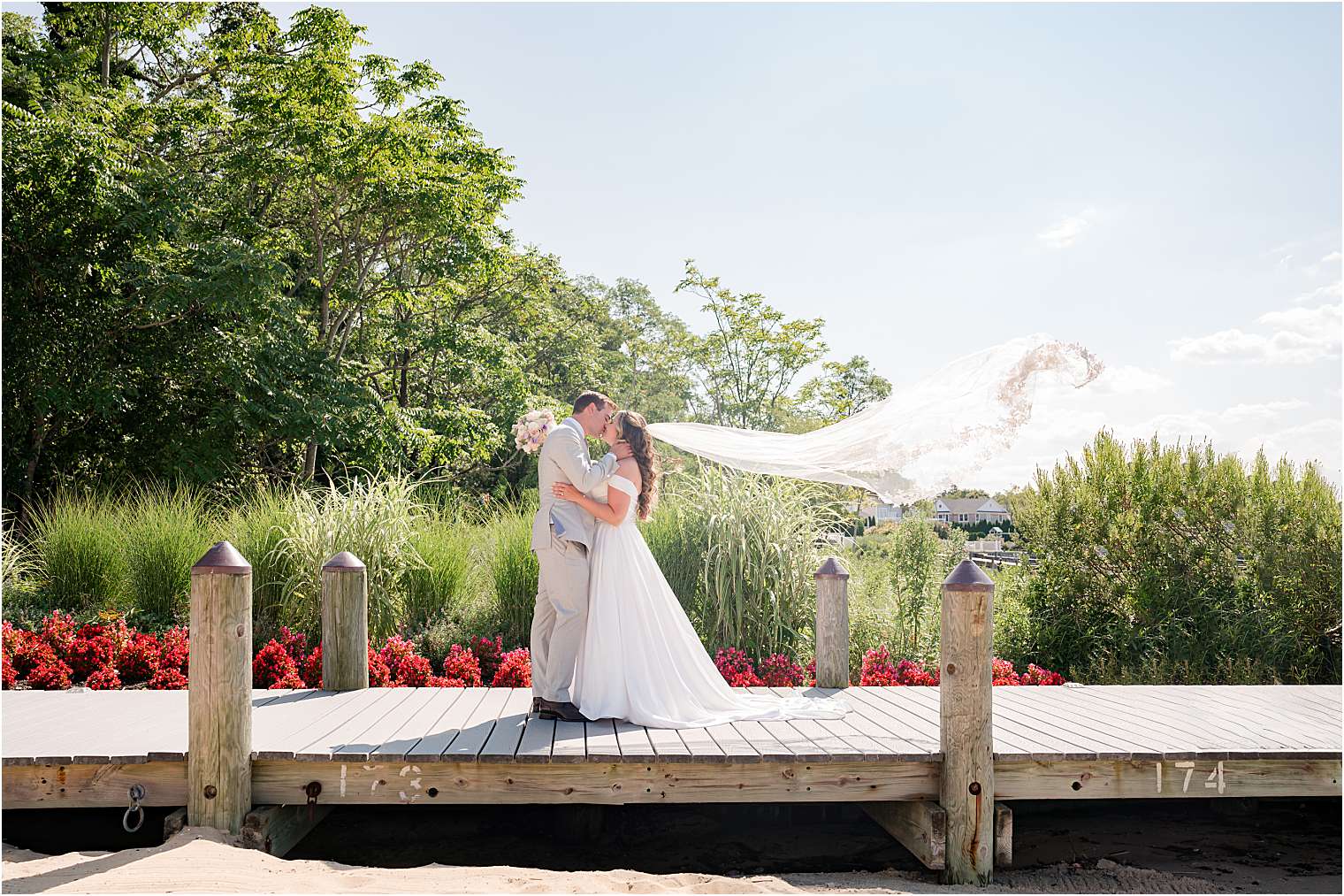 Bride and bride kissing on the dock