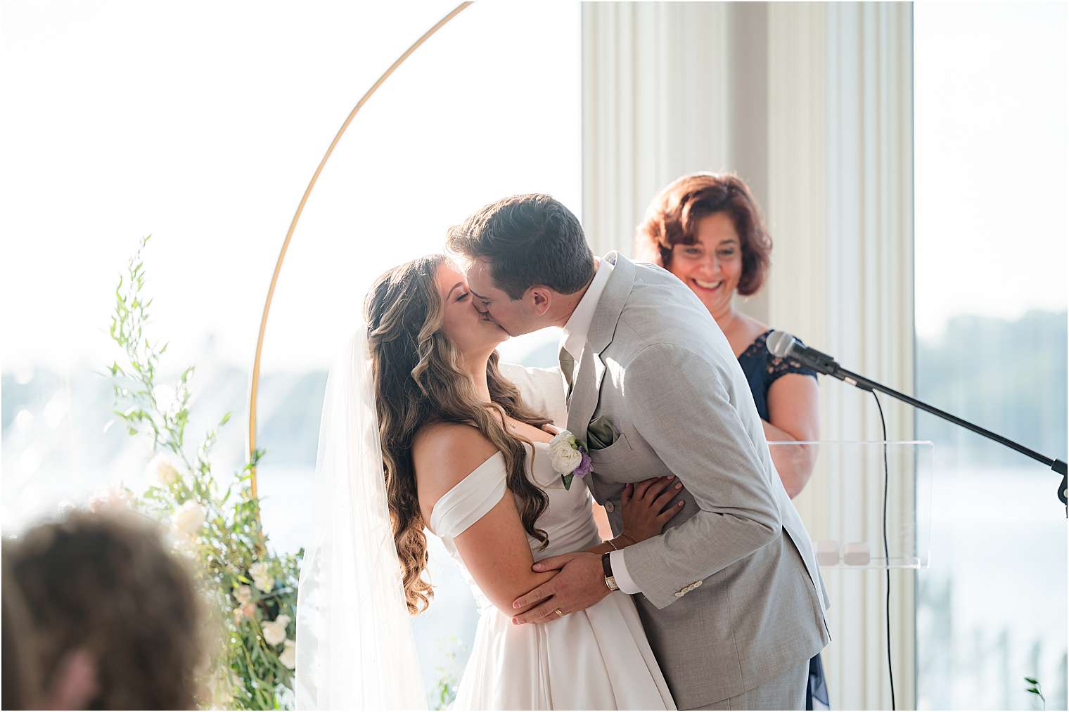 Bride and groom kissing at the altar