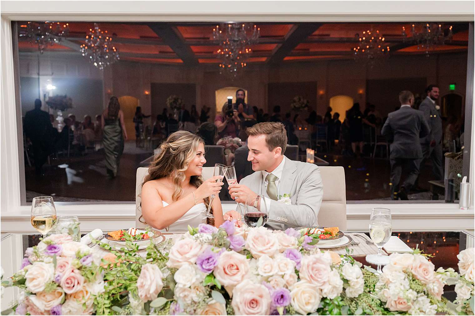 Bride and groom toasting at the sweetheart table