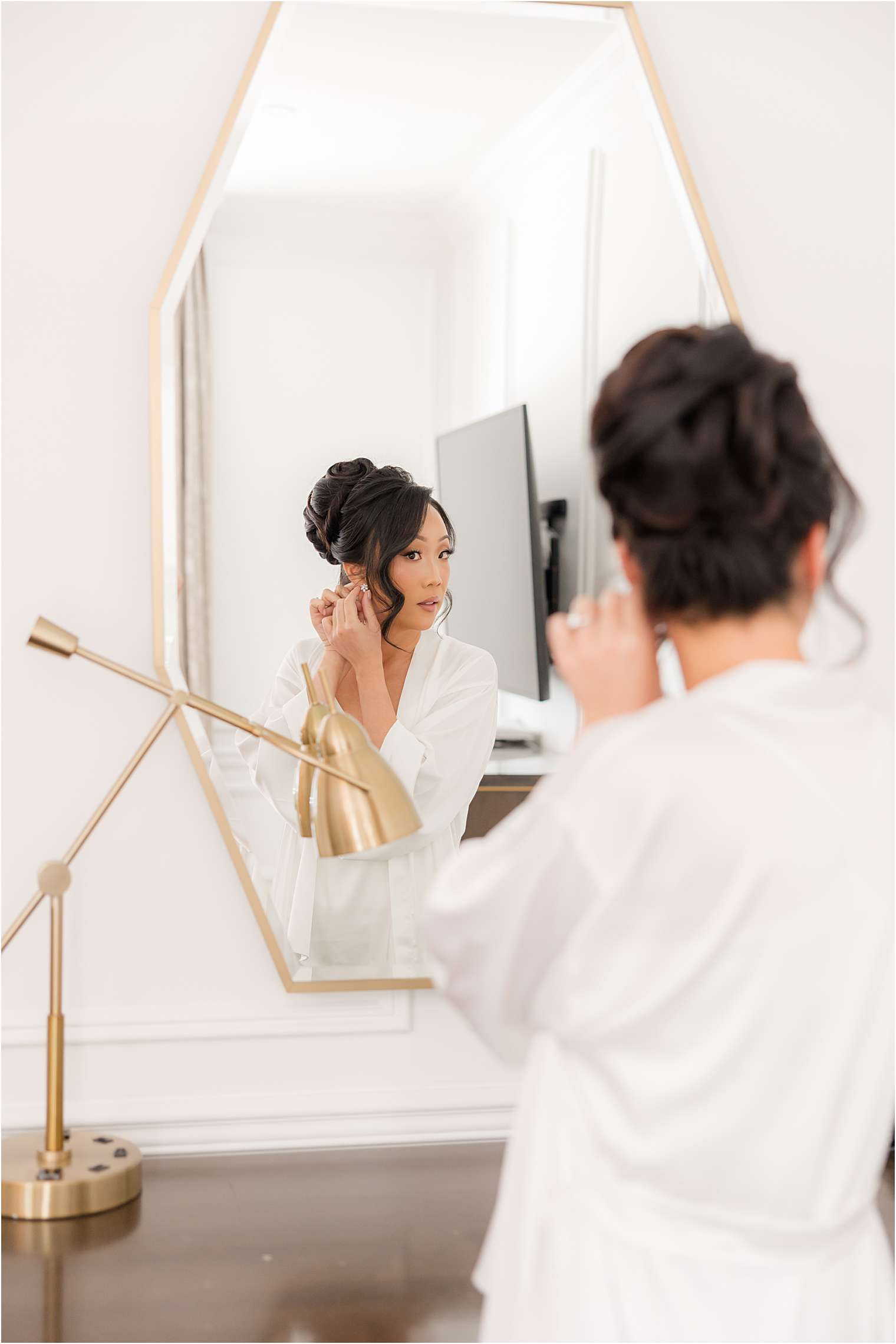 bride getting ready putting on her earrings