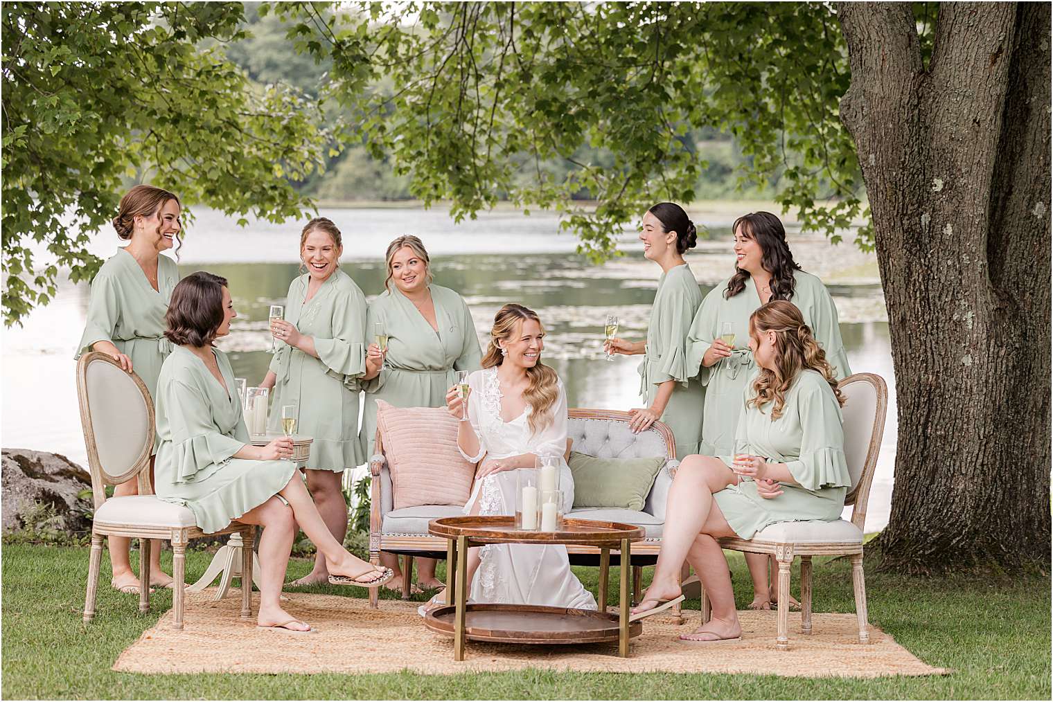 bride having fun with her bridesmaids at the lake