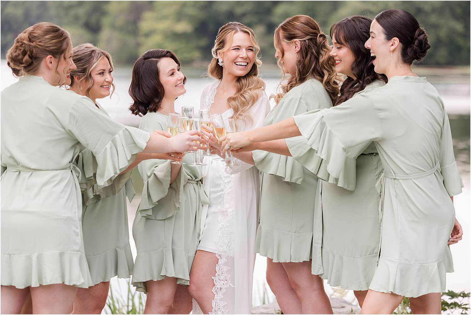 bride having fun with her bridesmaids at the lake