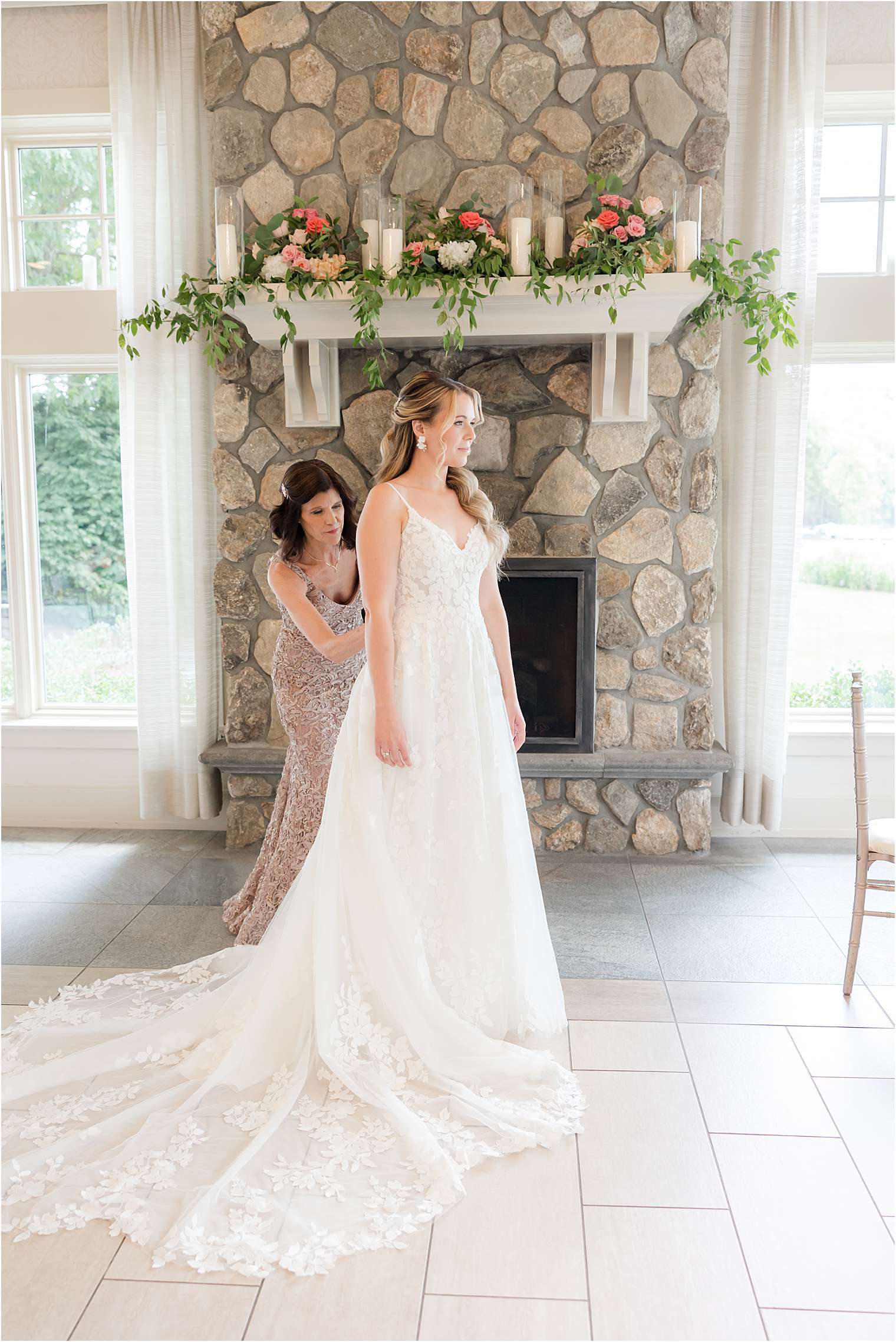 bridesmaid helping the bride with final touches