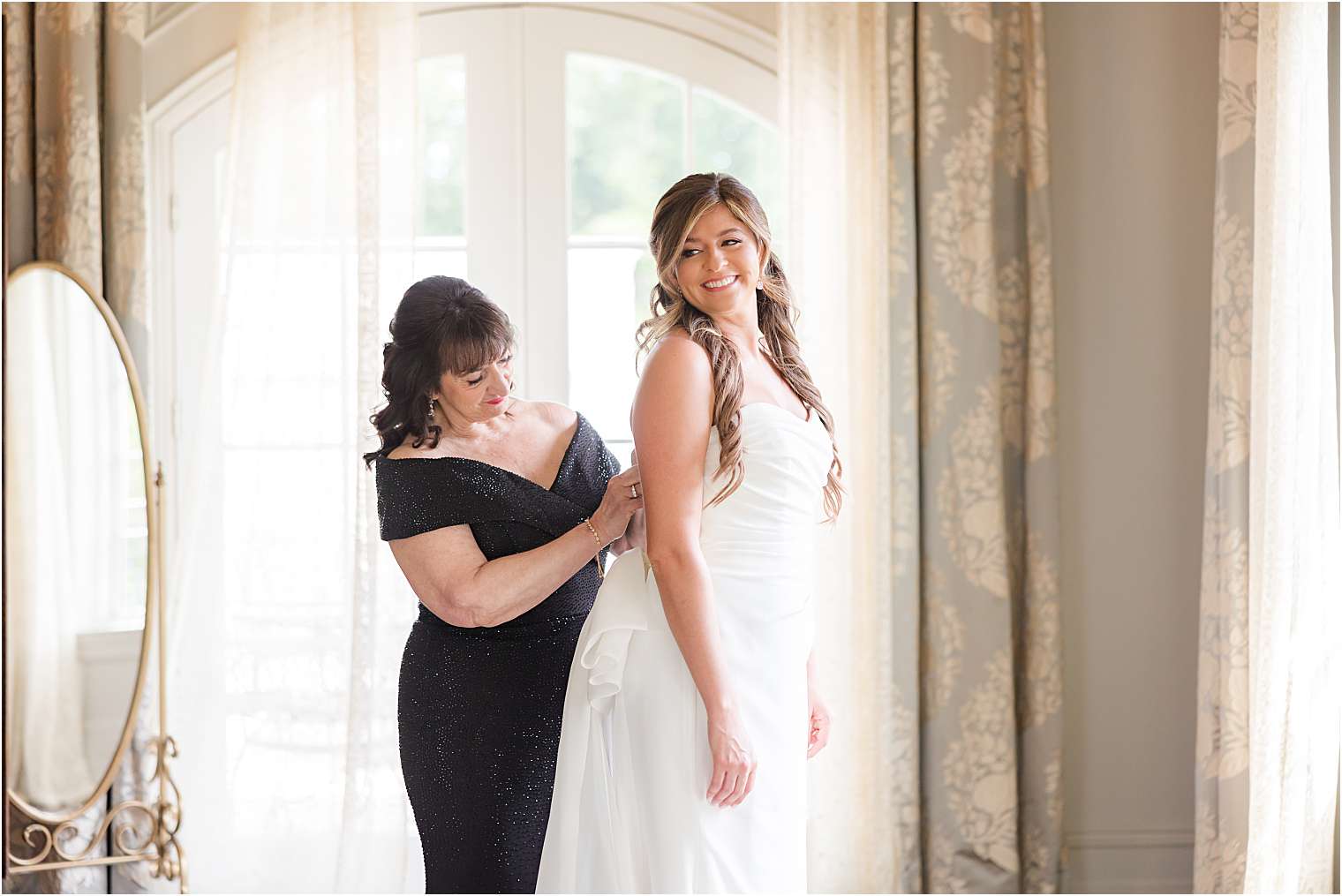 bride's mother helping her to get ready 