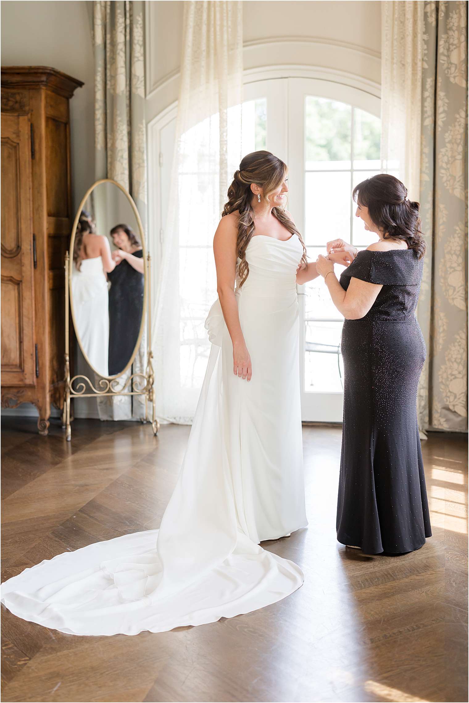 bride's mother helping her to get ready 