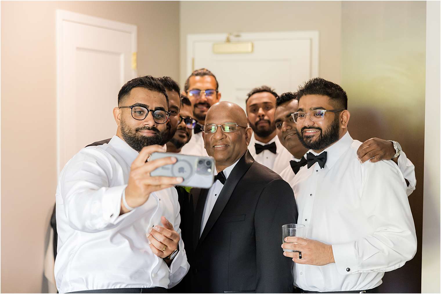 groom taking a selfie with his groomsmen