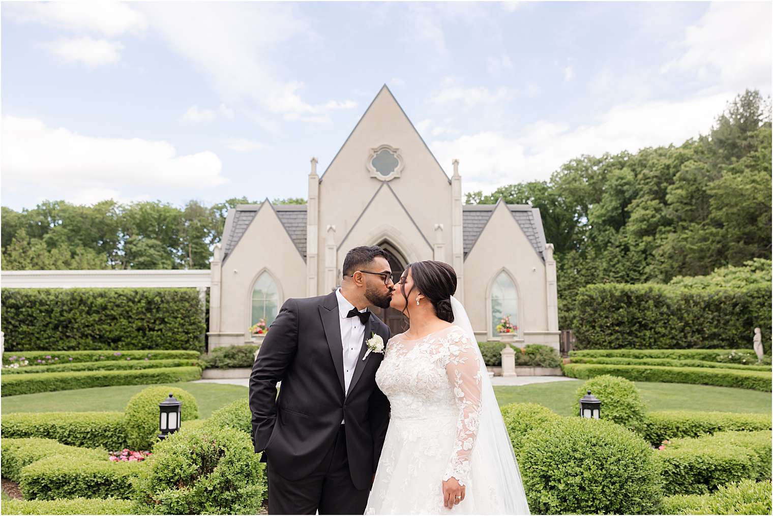 bride and groom in front of the chapel