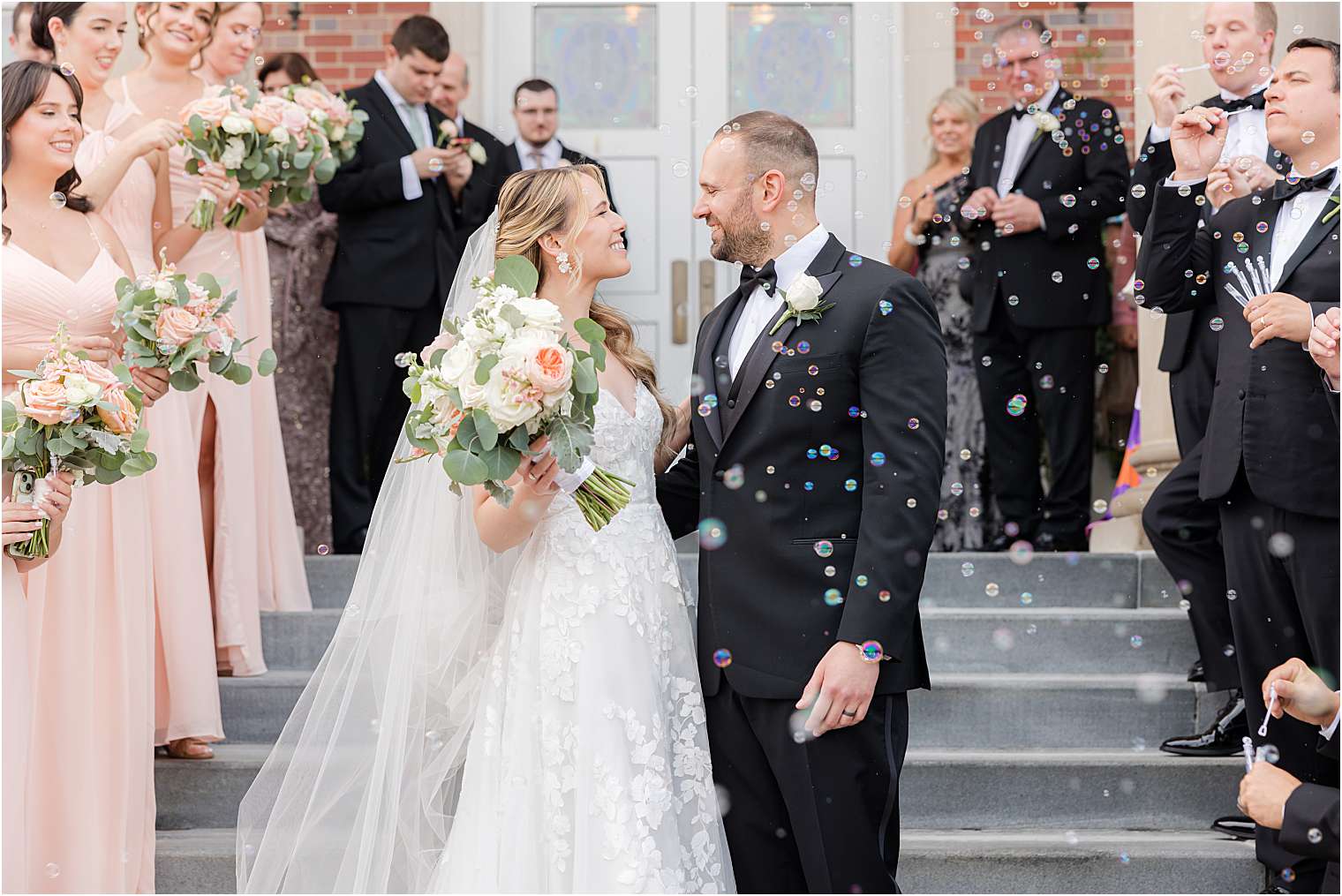 husband and wife kissing outside the church