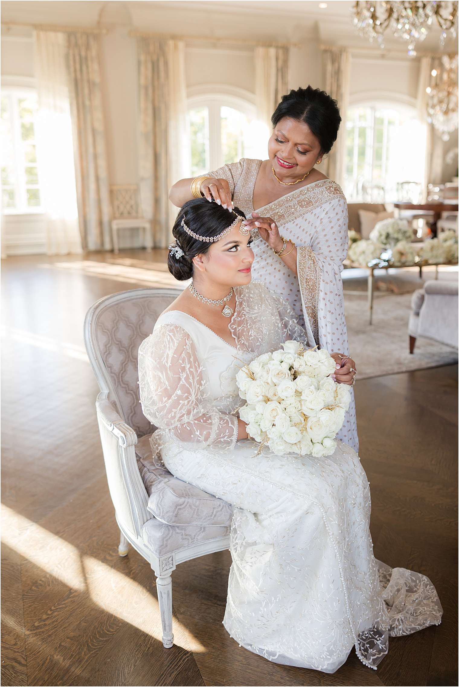 the mother lovingly adjusts the bride's intricate headpiece.