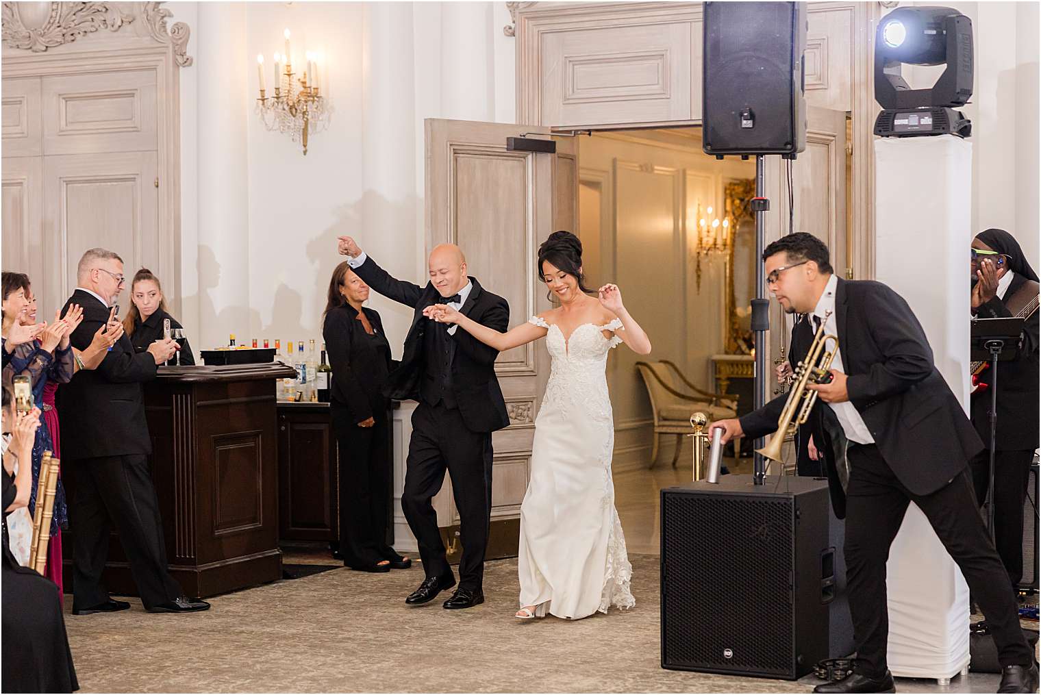 Bride and groom entering the ballroom