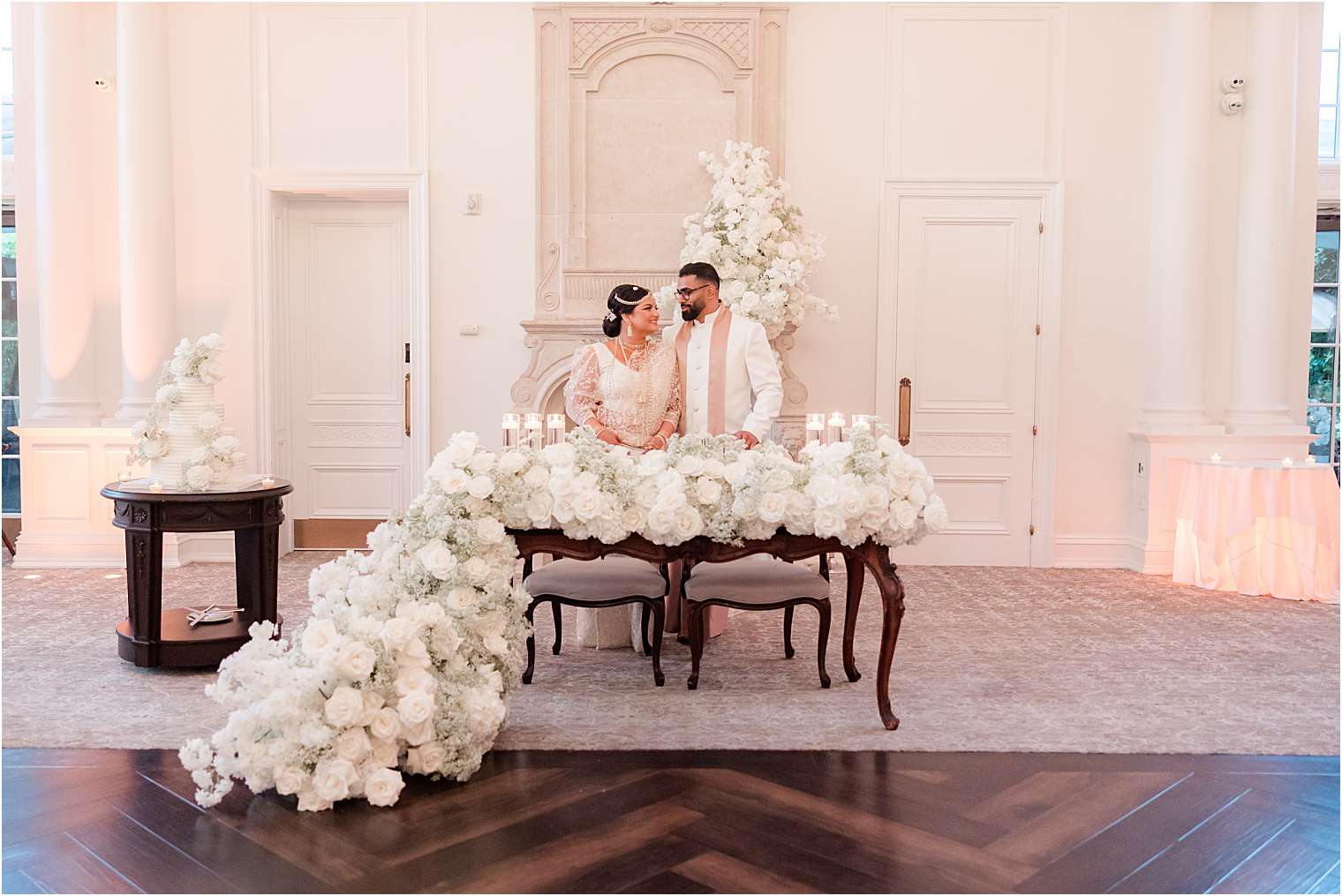 bride and groom seated at the sweetheart table