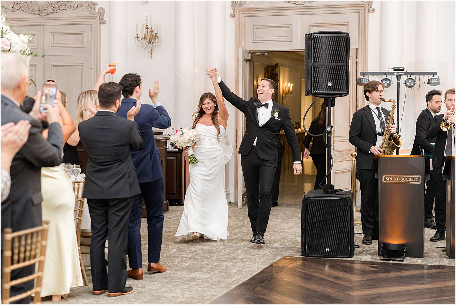 Bride and groom entering the ballroom