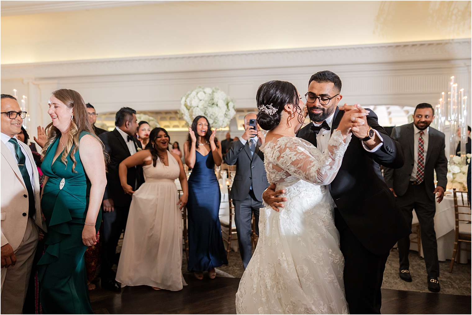 couple celebrating with their guests in the ballroom