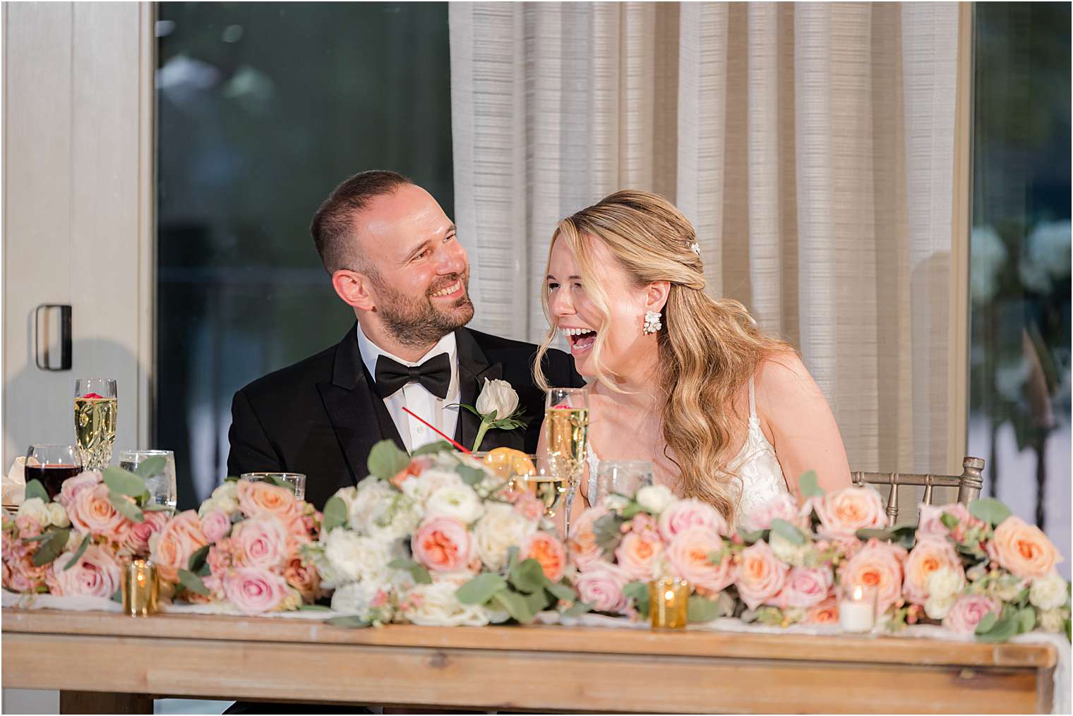 husband and wife sitting at their sweetheart table