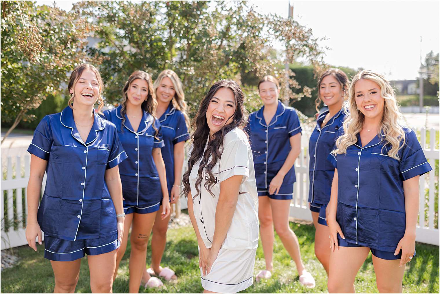 bride having fun with her bridesmaids outside 