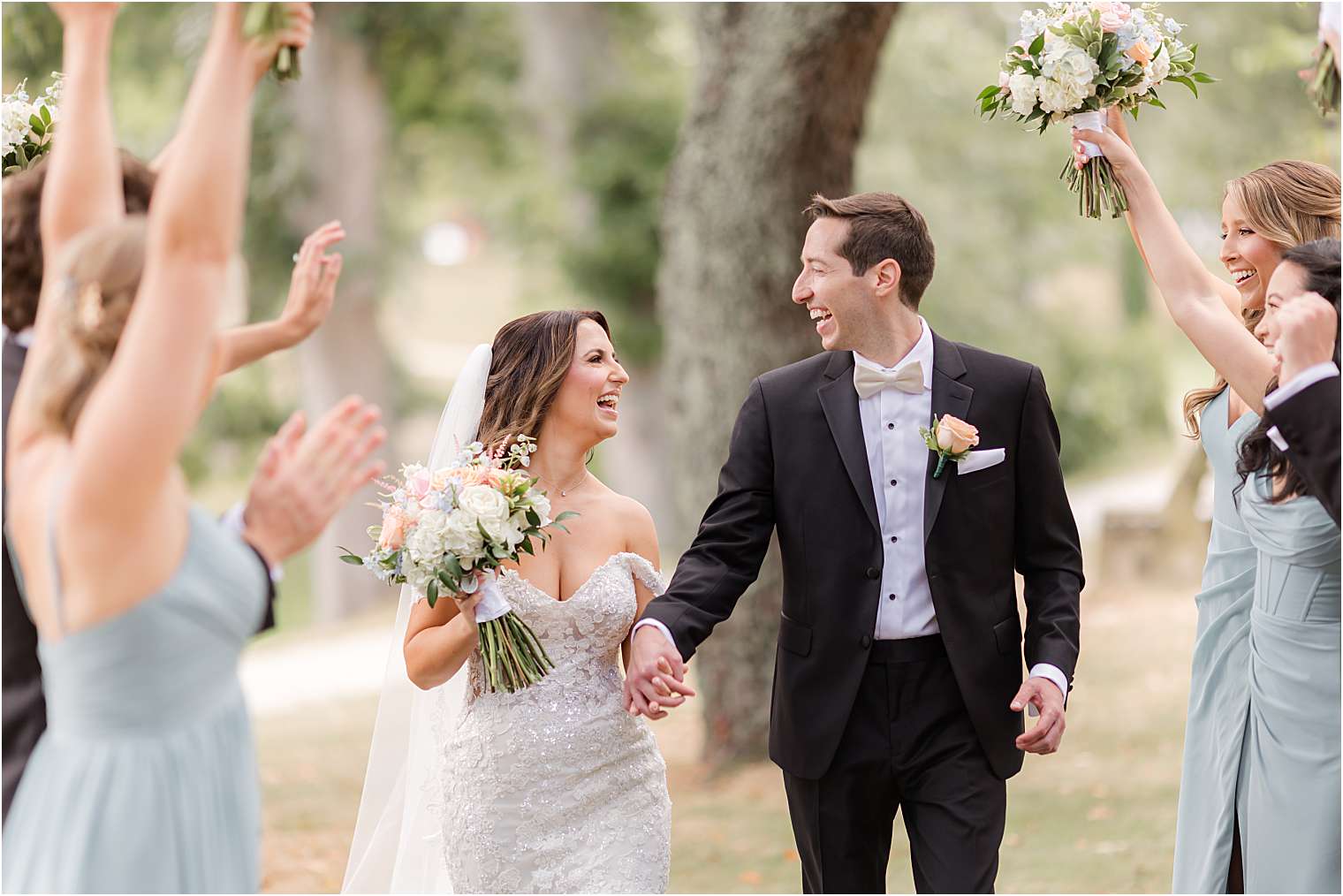 Bride and groom with their bridesmaids and groomsmen celebrating