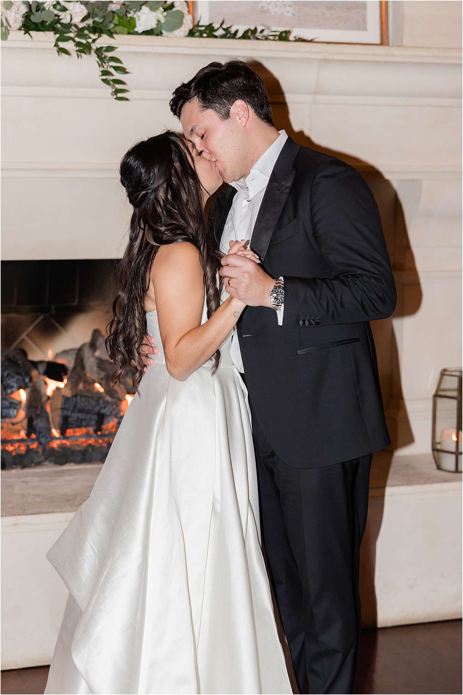 couple kissing in front of the fireplace