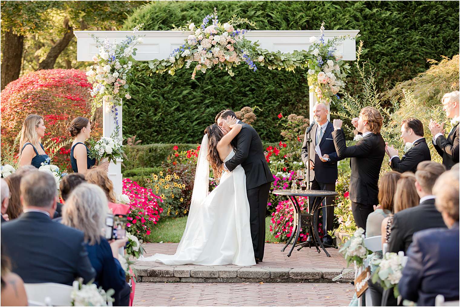 Husband and wife sharing a kiss at the altar 