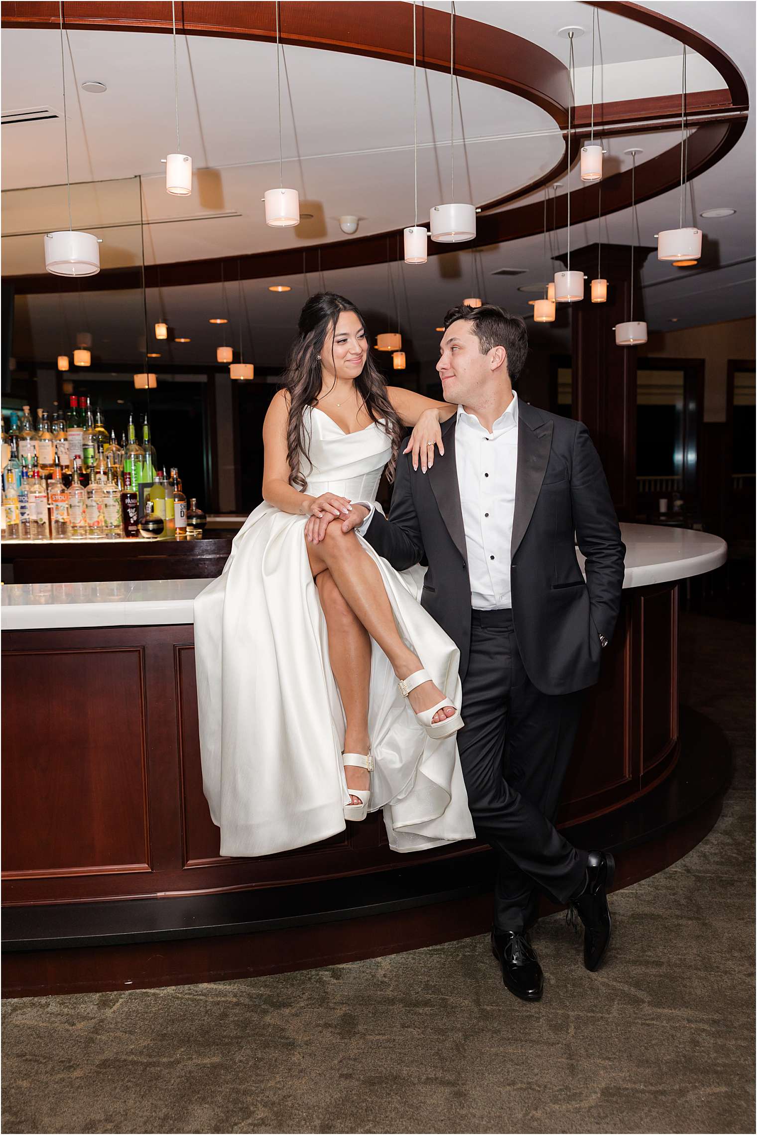 husband and wife at the bar, looking at each other 