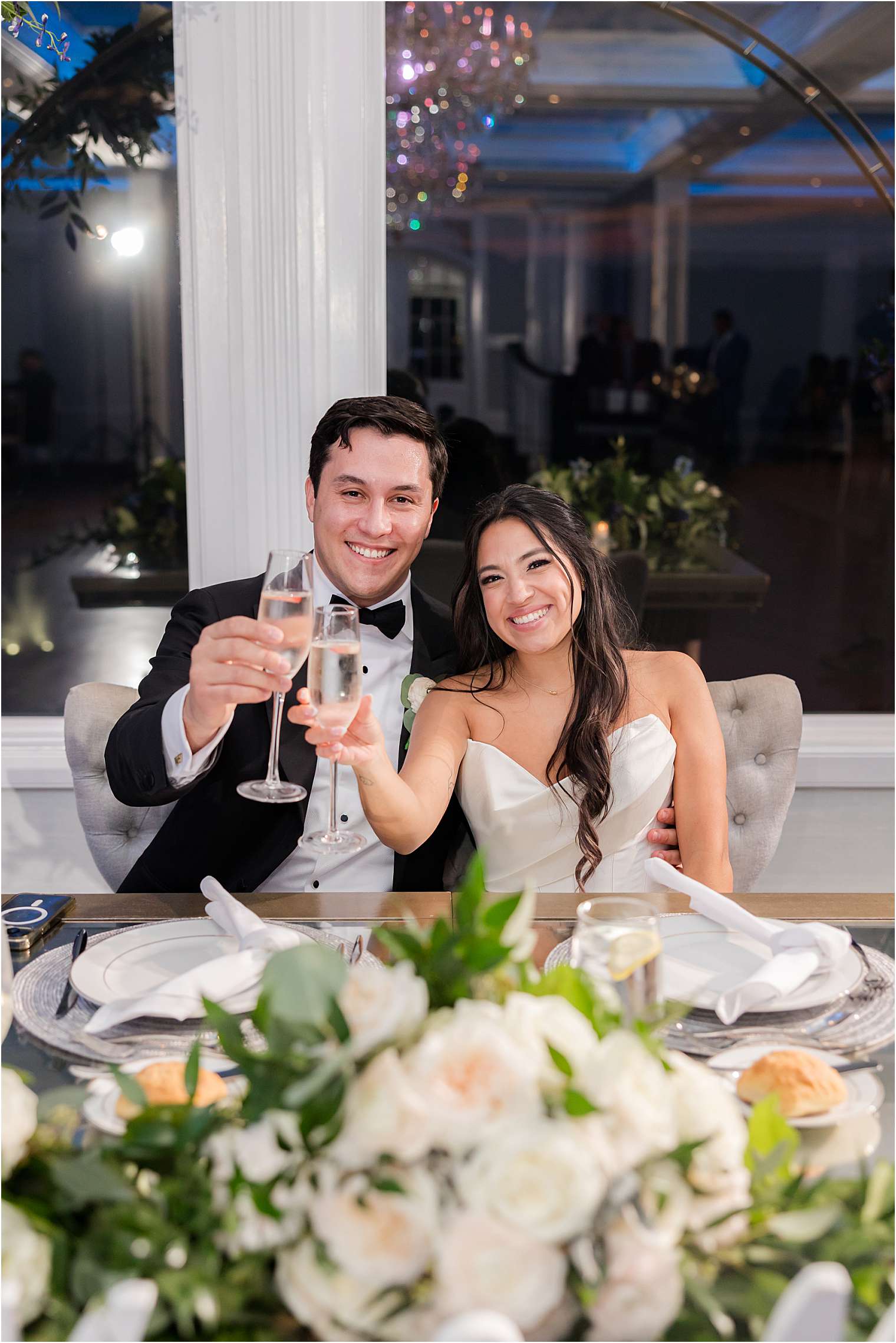 husband and wife sitting at their sweetheart table