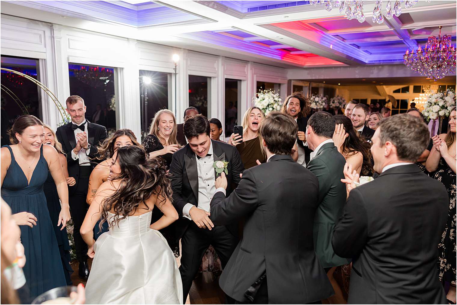 husband and wife dancing with their guests 