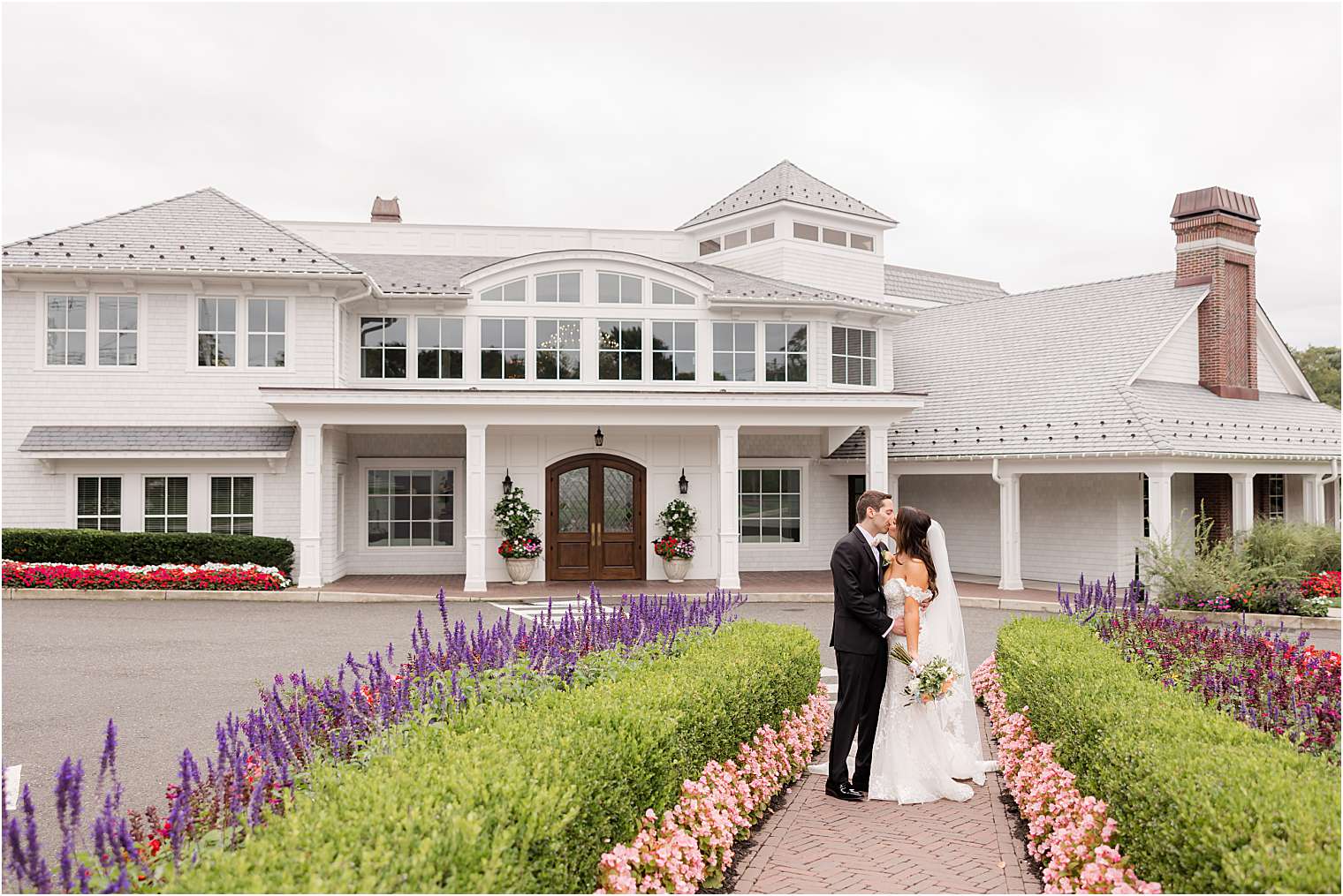 husband and wife kissing between the flowers