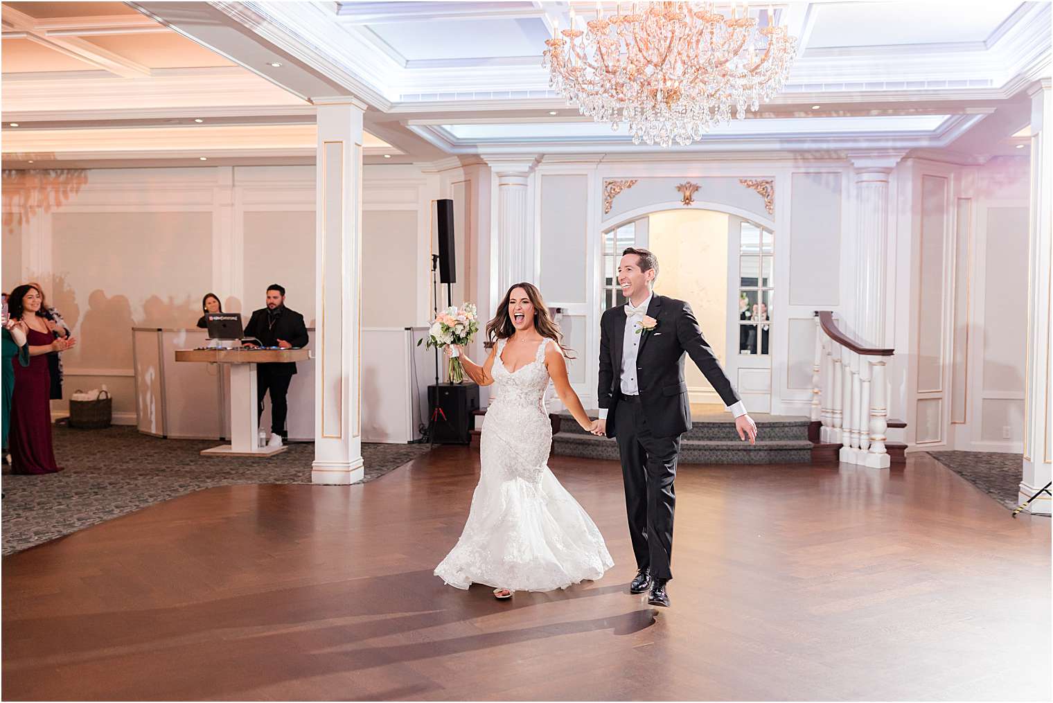 Bride and groom entering the ballroom