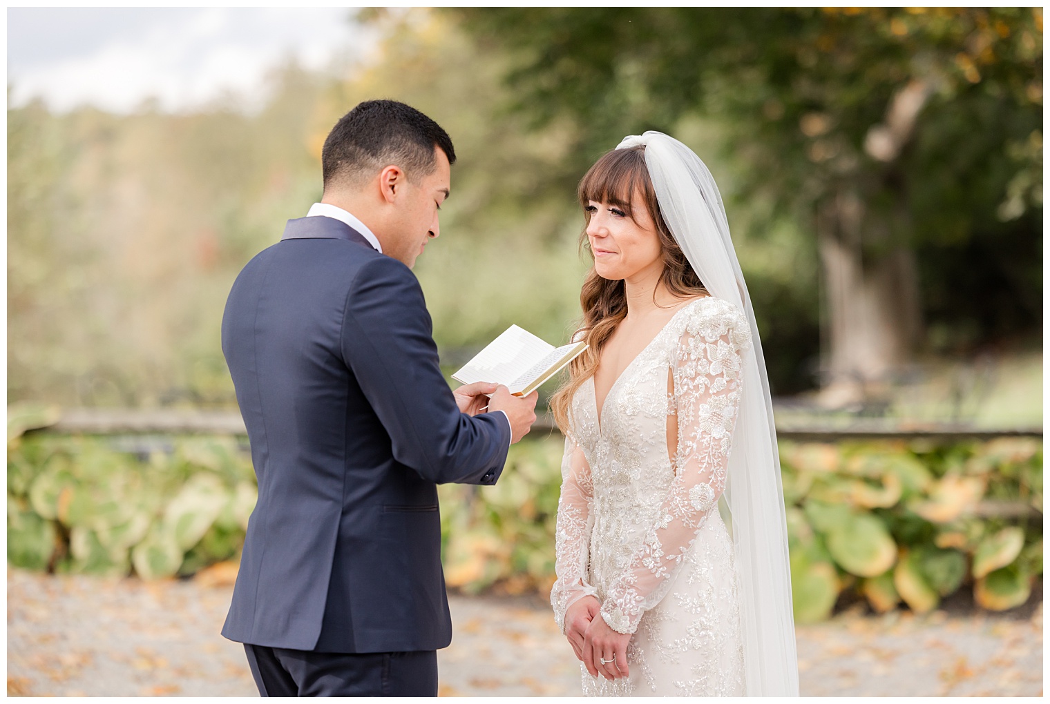 groom reading a love letter to his bride