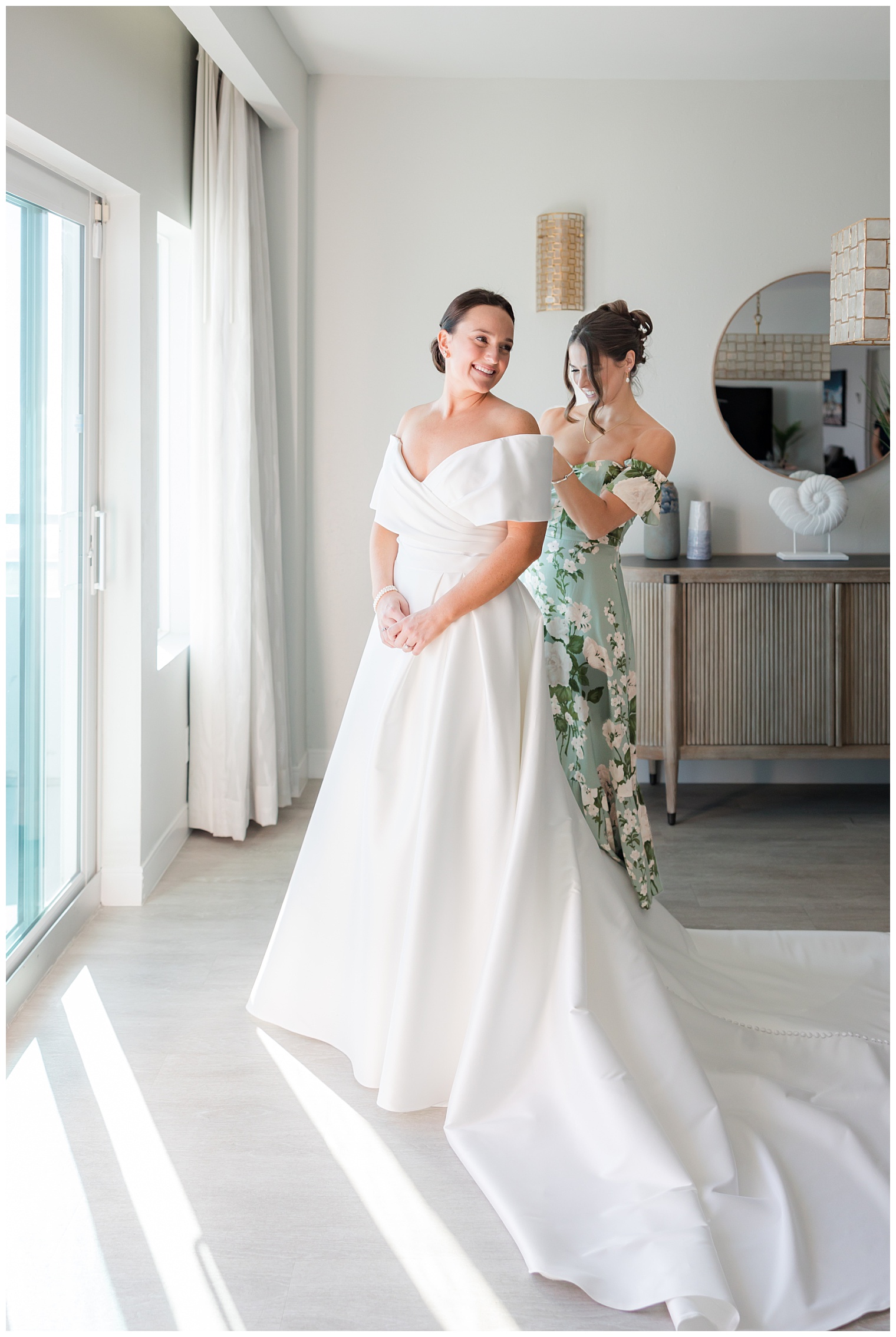 bridesmaid helping the bride getting ready