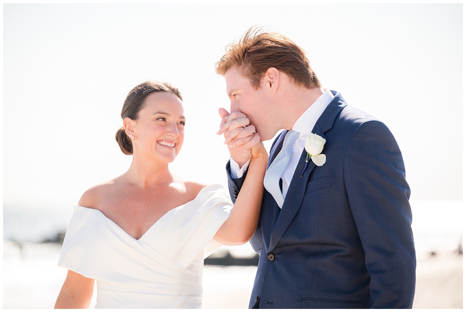 groom kissing the bride's hand