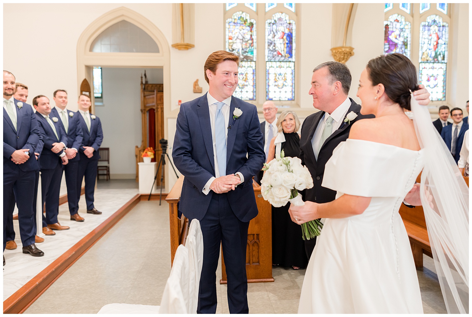 groom and bride in front of the altar