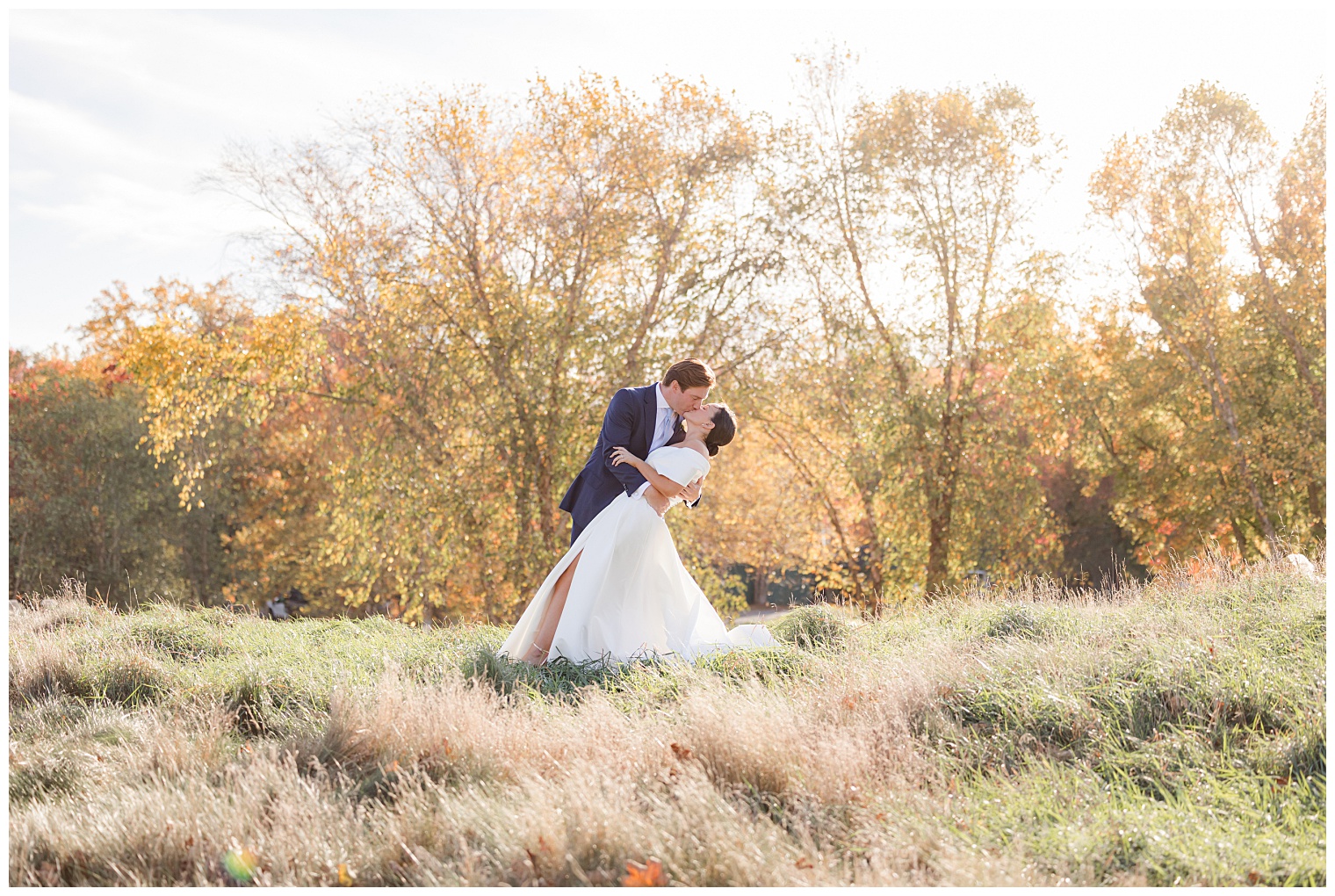 groom and bride kissing at the sunset 