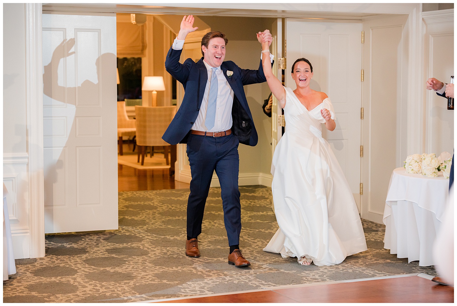 bride and groom entering the ballroom