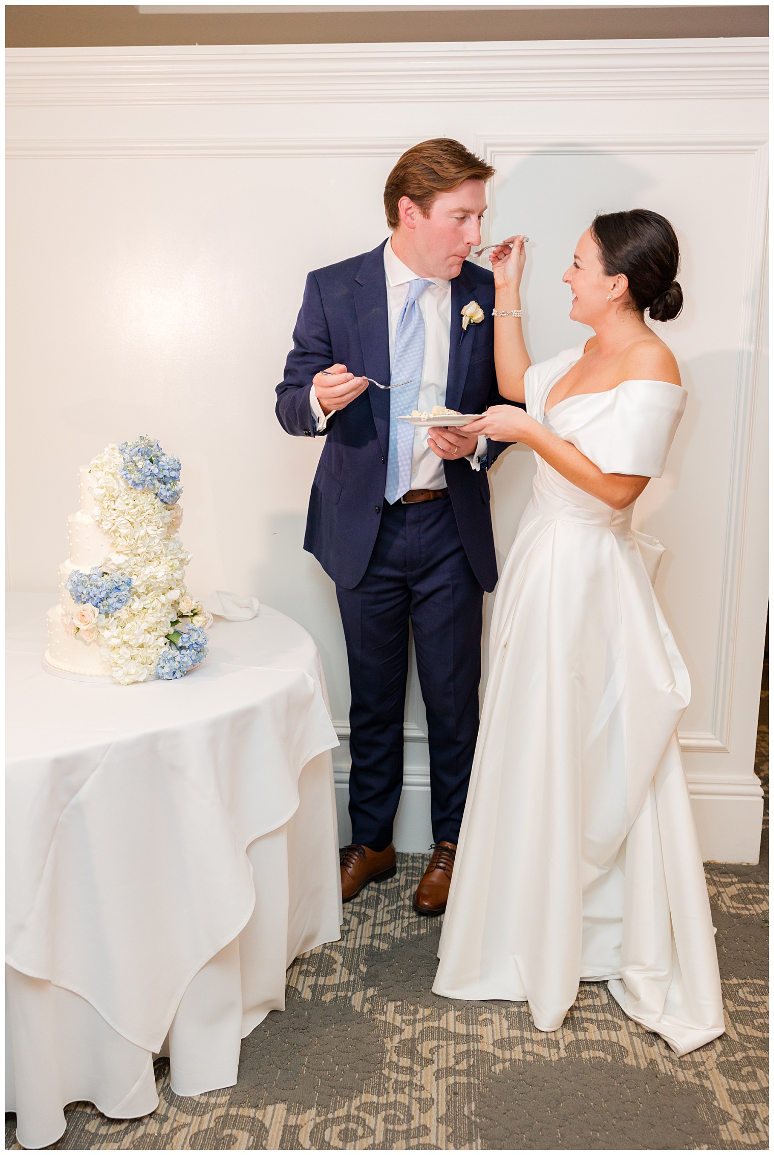 groom eating the wedding cake