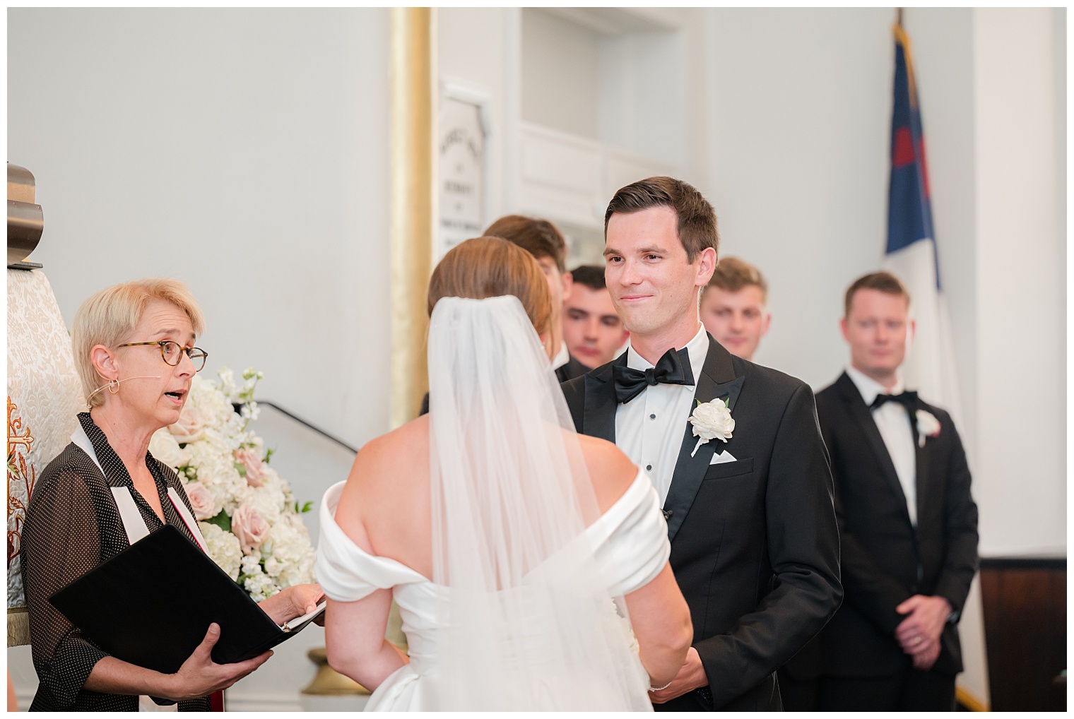 groom and bride in front of the altar